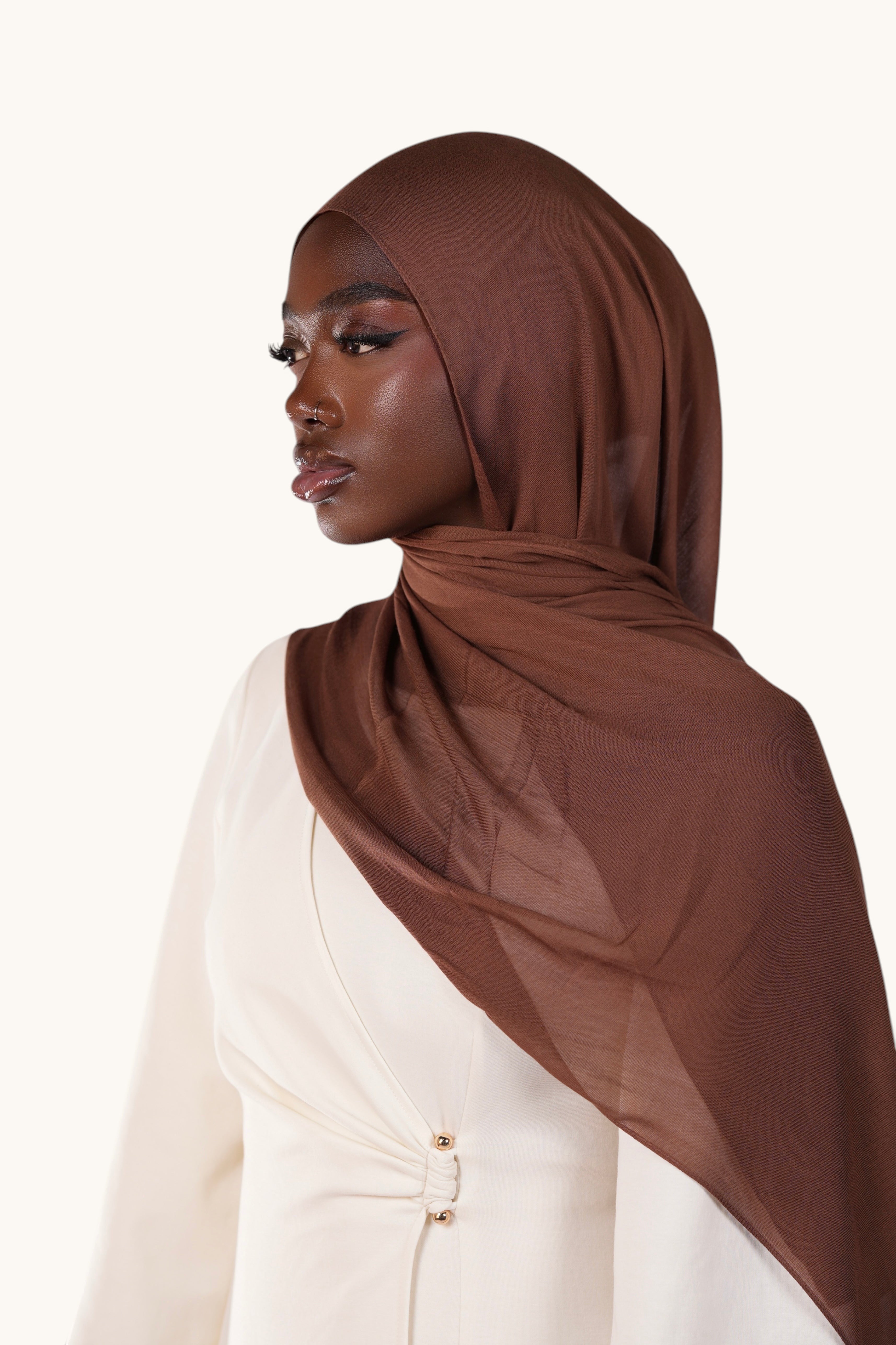 Model wearing a LOSYANA chocolate brown lightweight modal hijab with a soft, elegant drape and sheer finish.