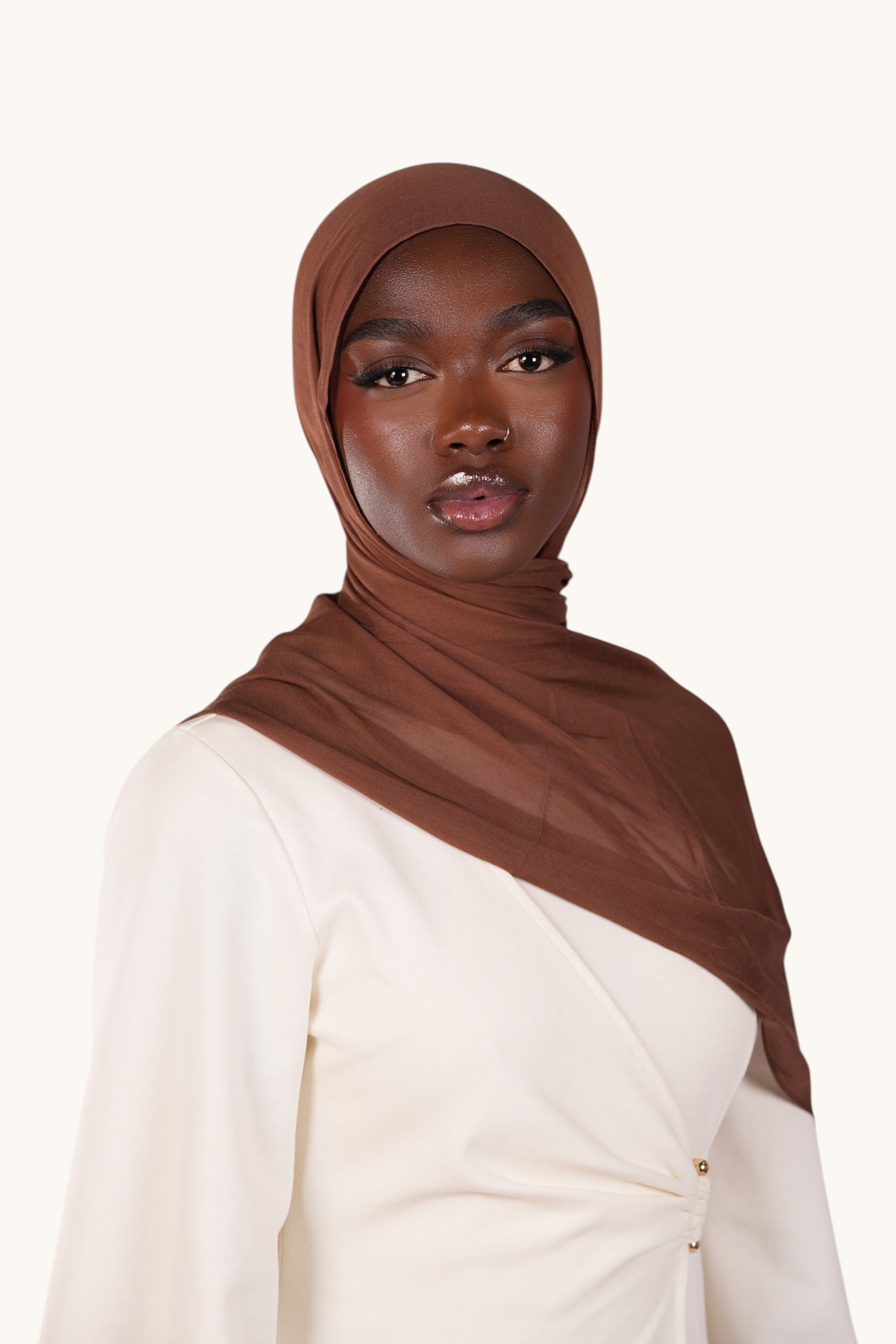 LOSYANA chocolate brown lightweight modal hijab worn by a model in a white top, featuring a soft flowing drape.
