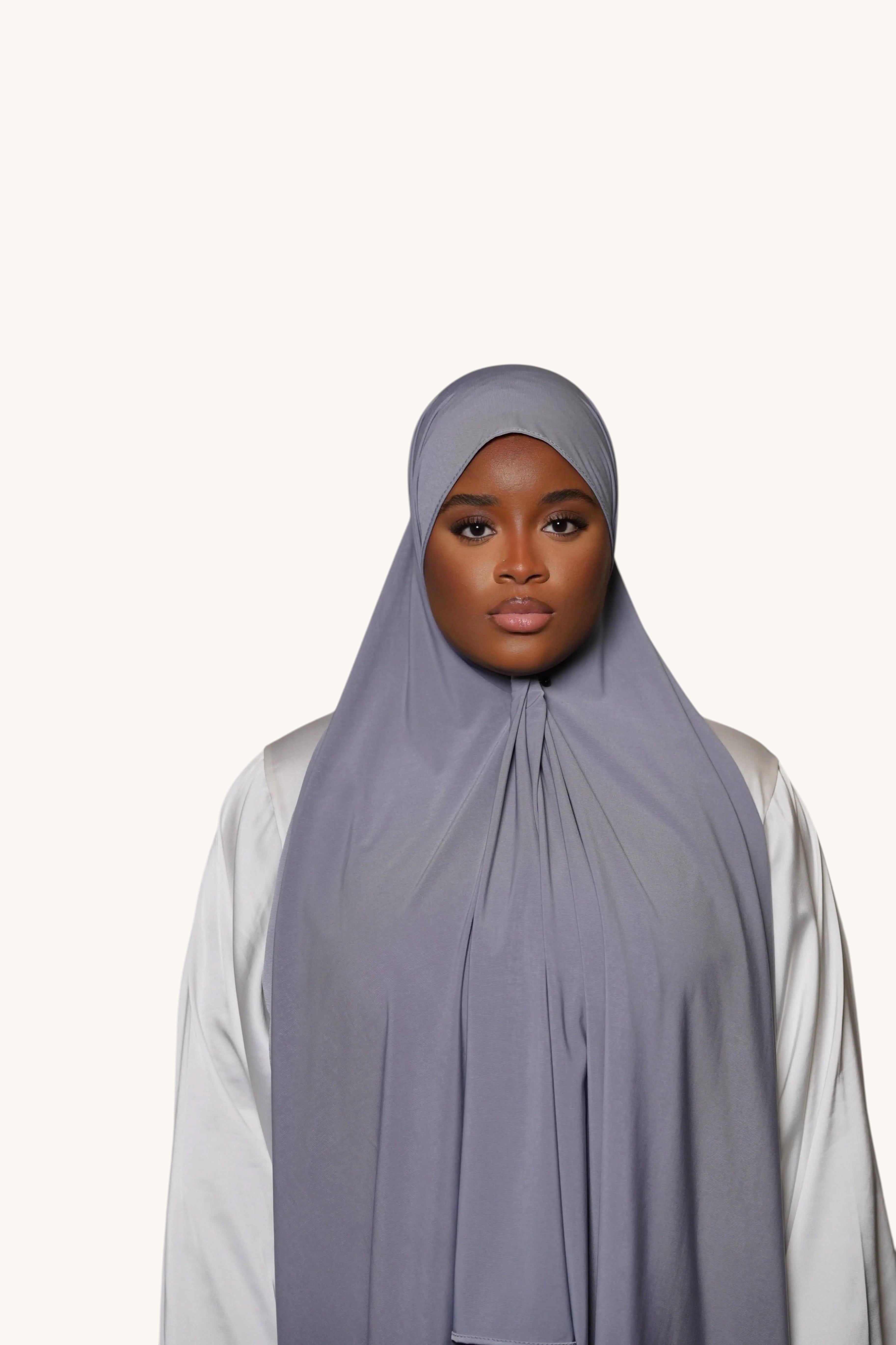 Model wearing a dark grey LOSYANA premium jersey hijab, featuring soft, non-transparent, and non-slip fabric.