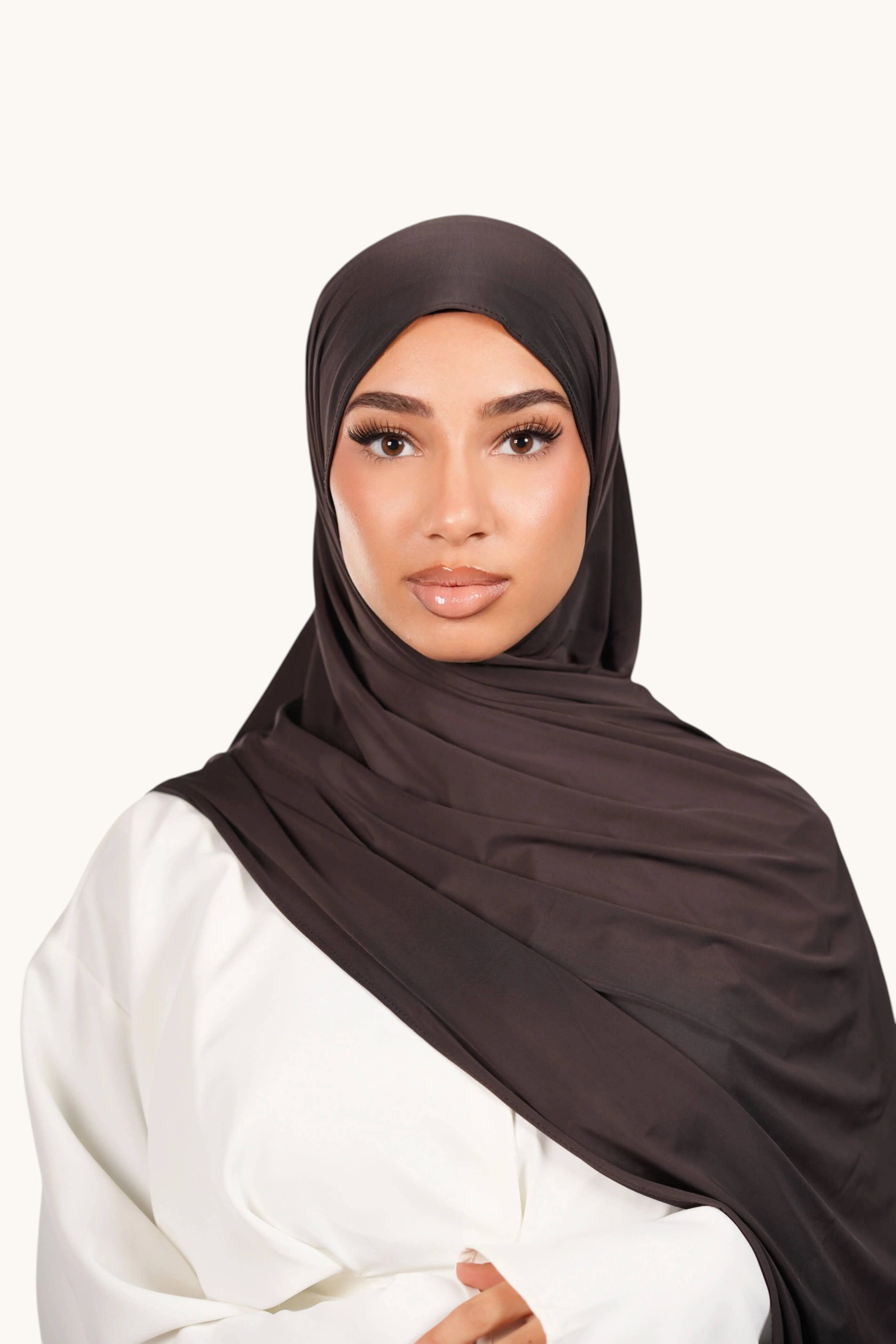 LOSYANA deep brown liquid jersey hijab worn by a model, featuring a lightweight, elegant, and breathable fabric.