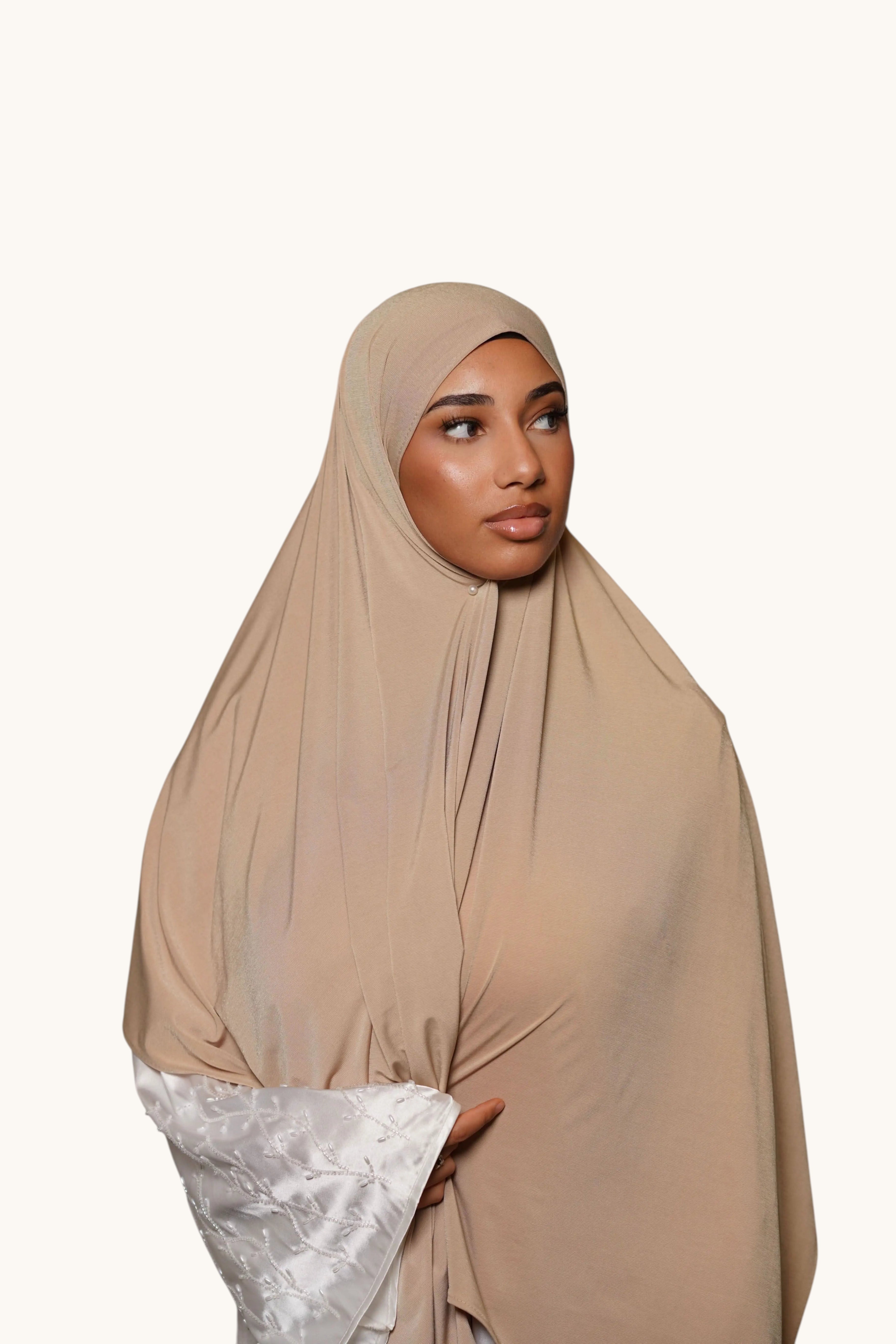 LOSYANA desert beige premium jersey hijab worn by a model, featuring a soft, non-slip, and opaque fabric drape.