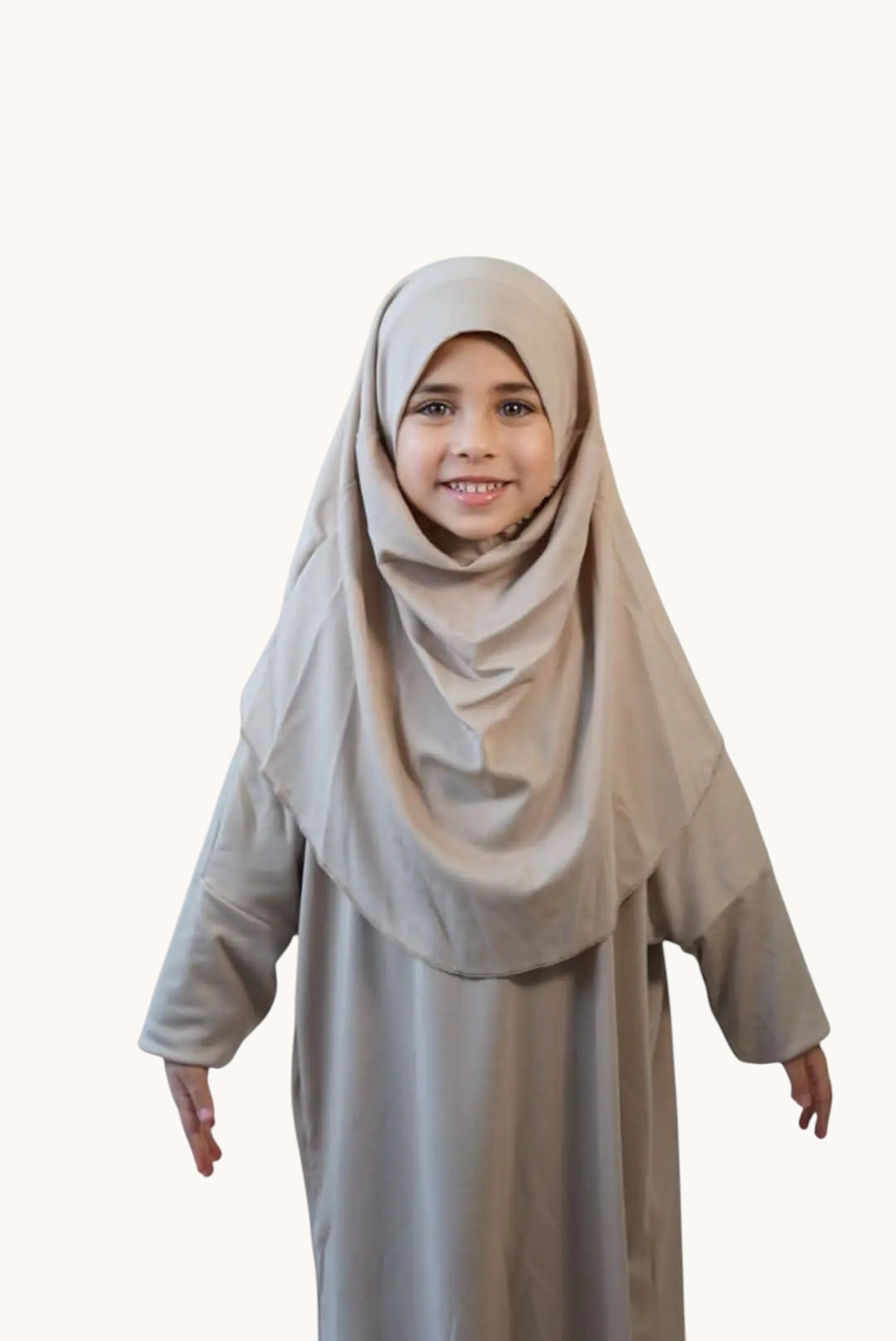 Young girl wearing a soft desert-coloured LOSYANA jersey prayer dress with an integrated hijab