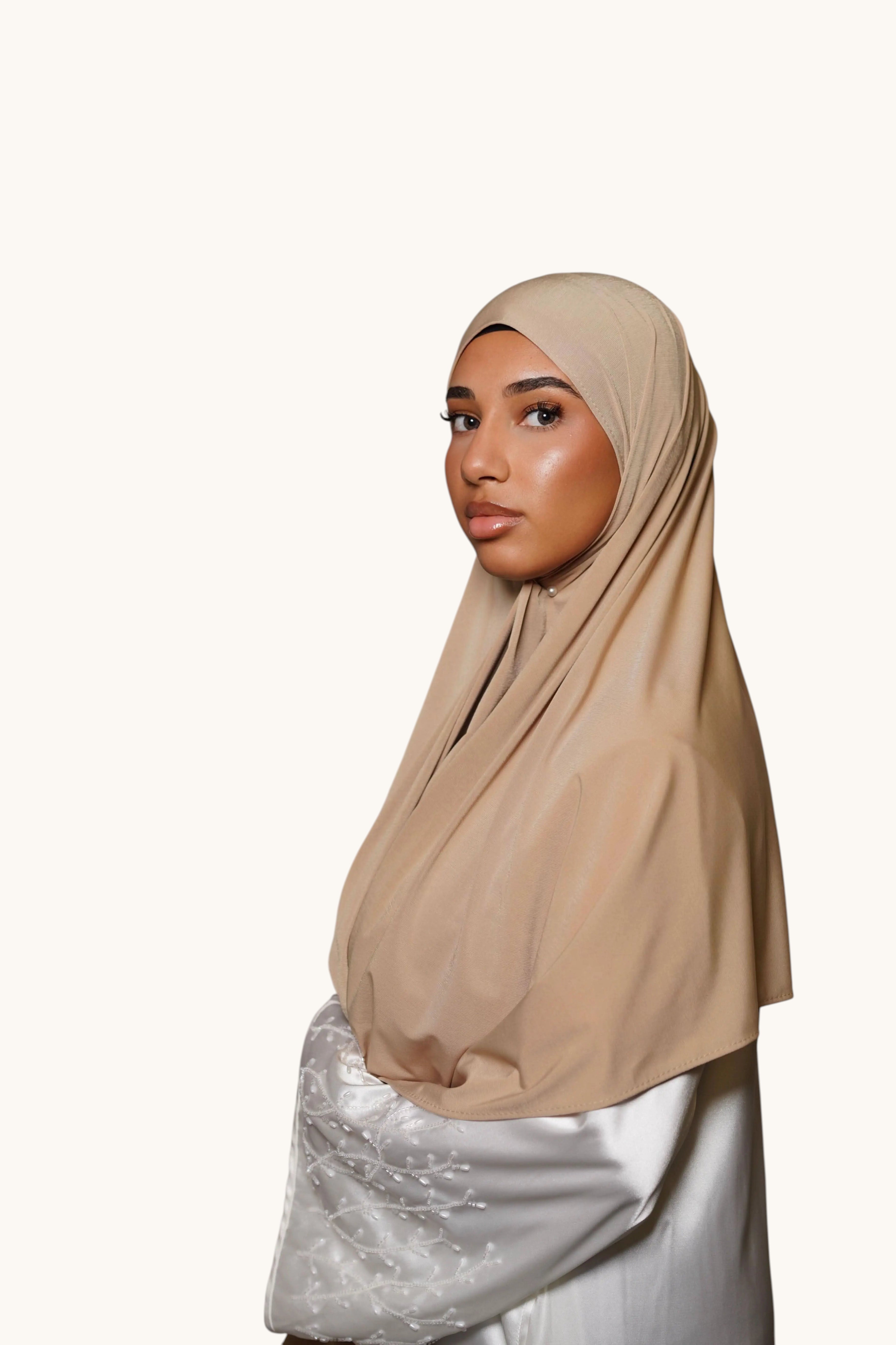 LOSYANA desert beige premium jersey hijab worn by a woman, featuring soft, non-slip, opaque fabric.