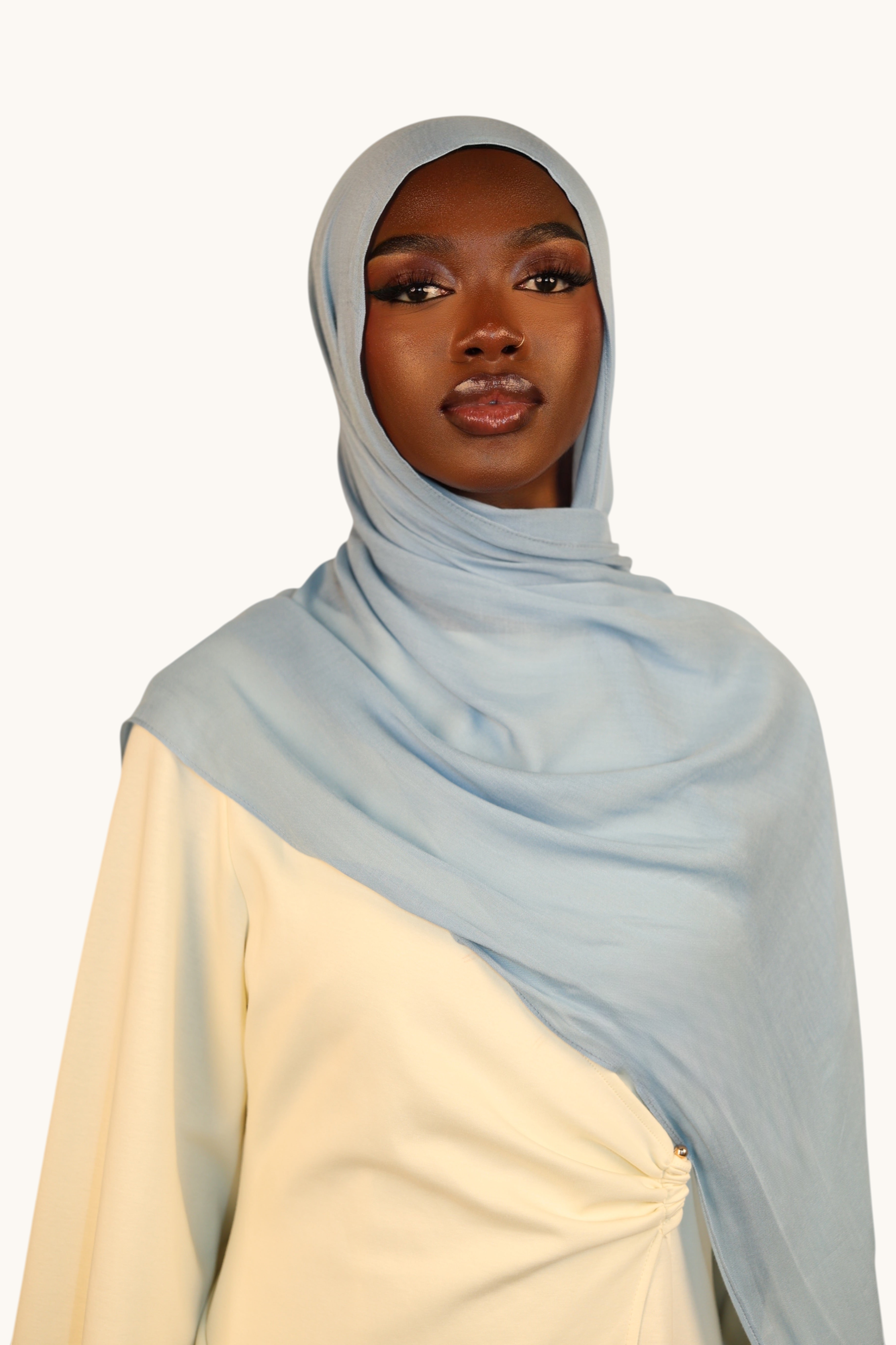 LOSYANA dusty blue lightweight modal hijab worn by a model, featuring a soft, elegant, and semi-sheer fabric drape.
