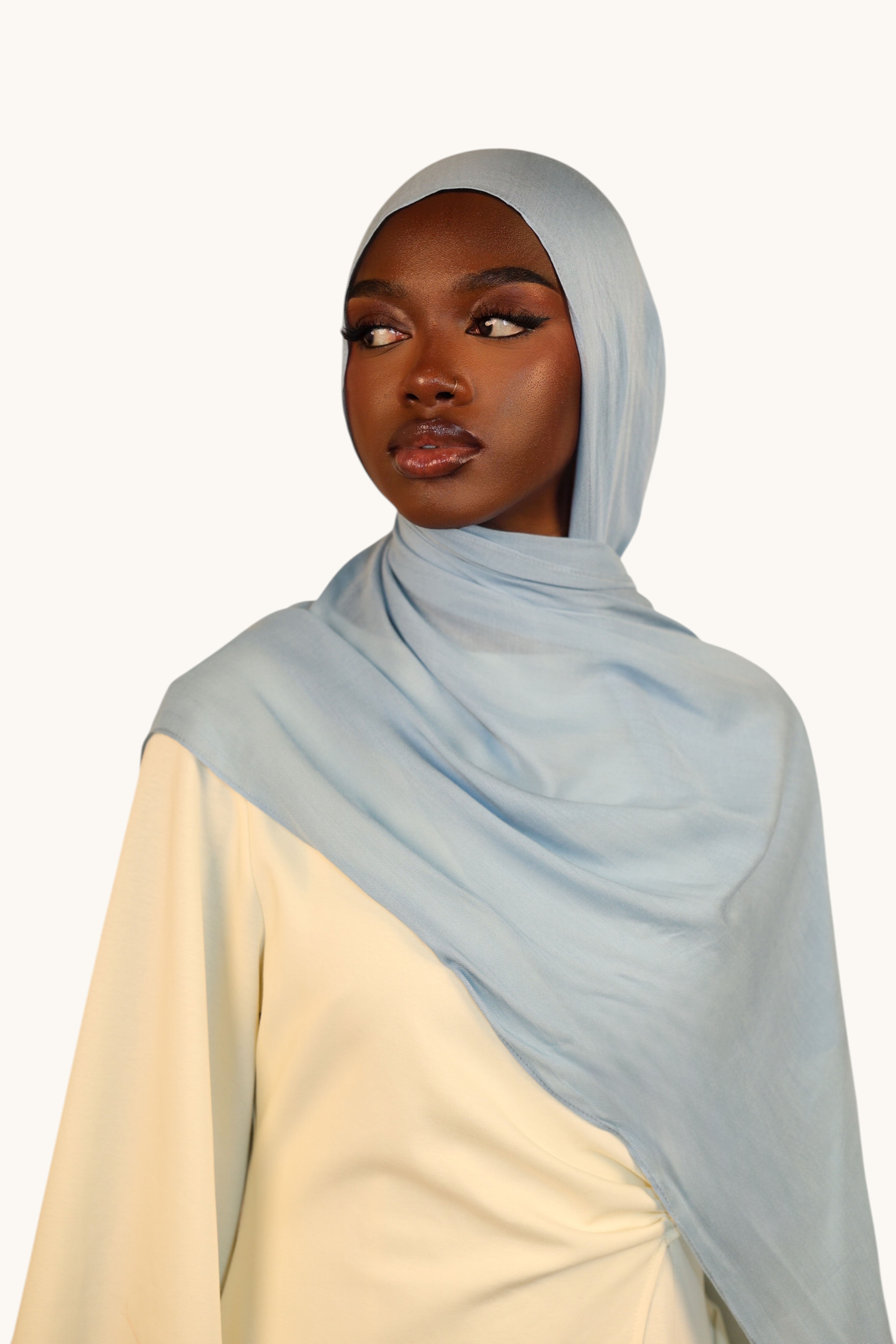 LOSYANA dusty blue lightweight modal hijab worn by a model with a flowing, elegant drape.