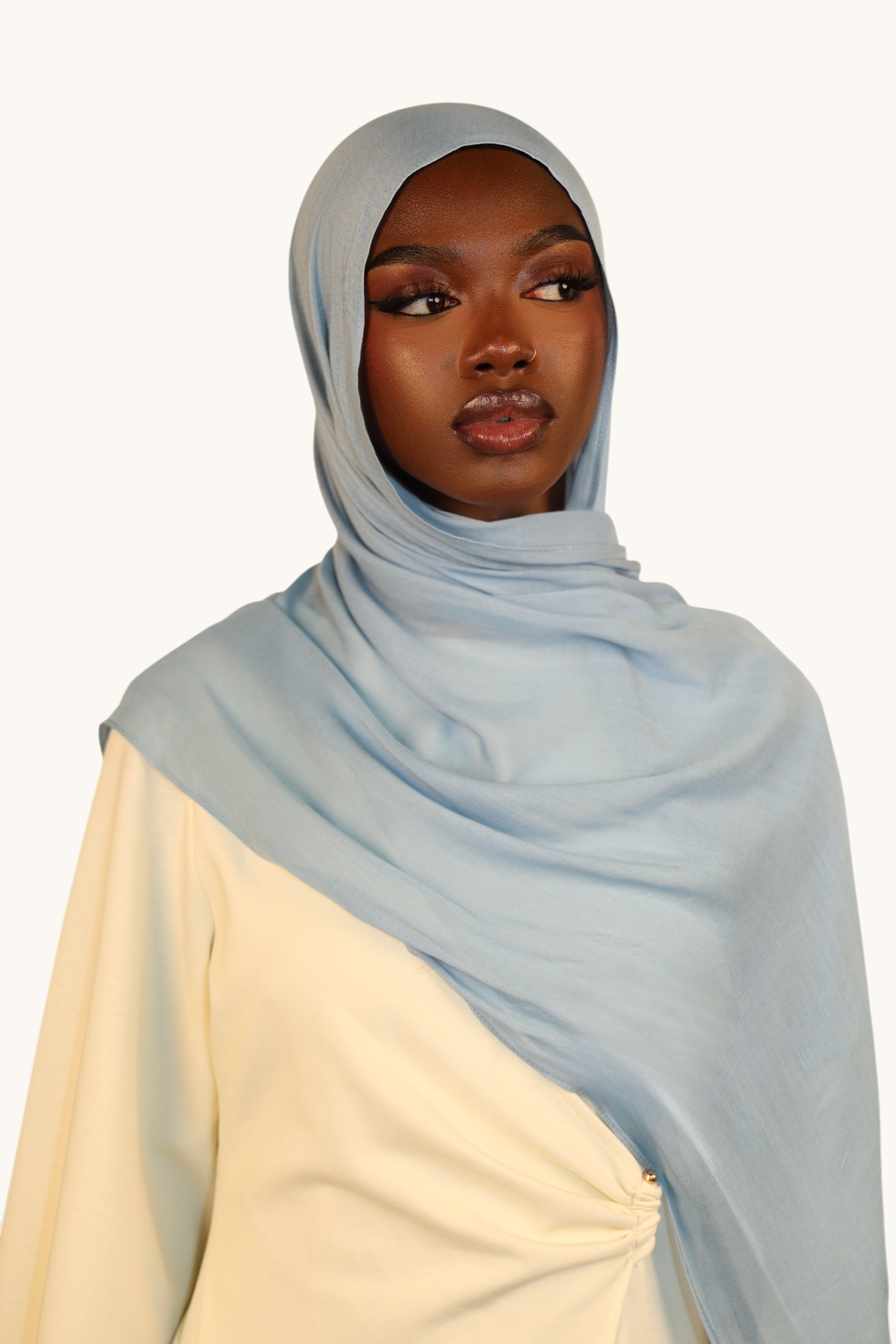 LOSYANA dusty blue lightweight modal hijab worn by a model with a matching undercap for an elegant draped look