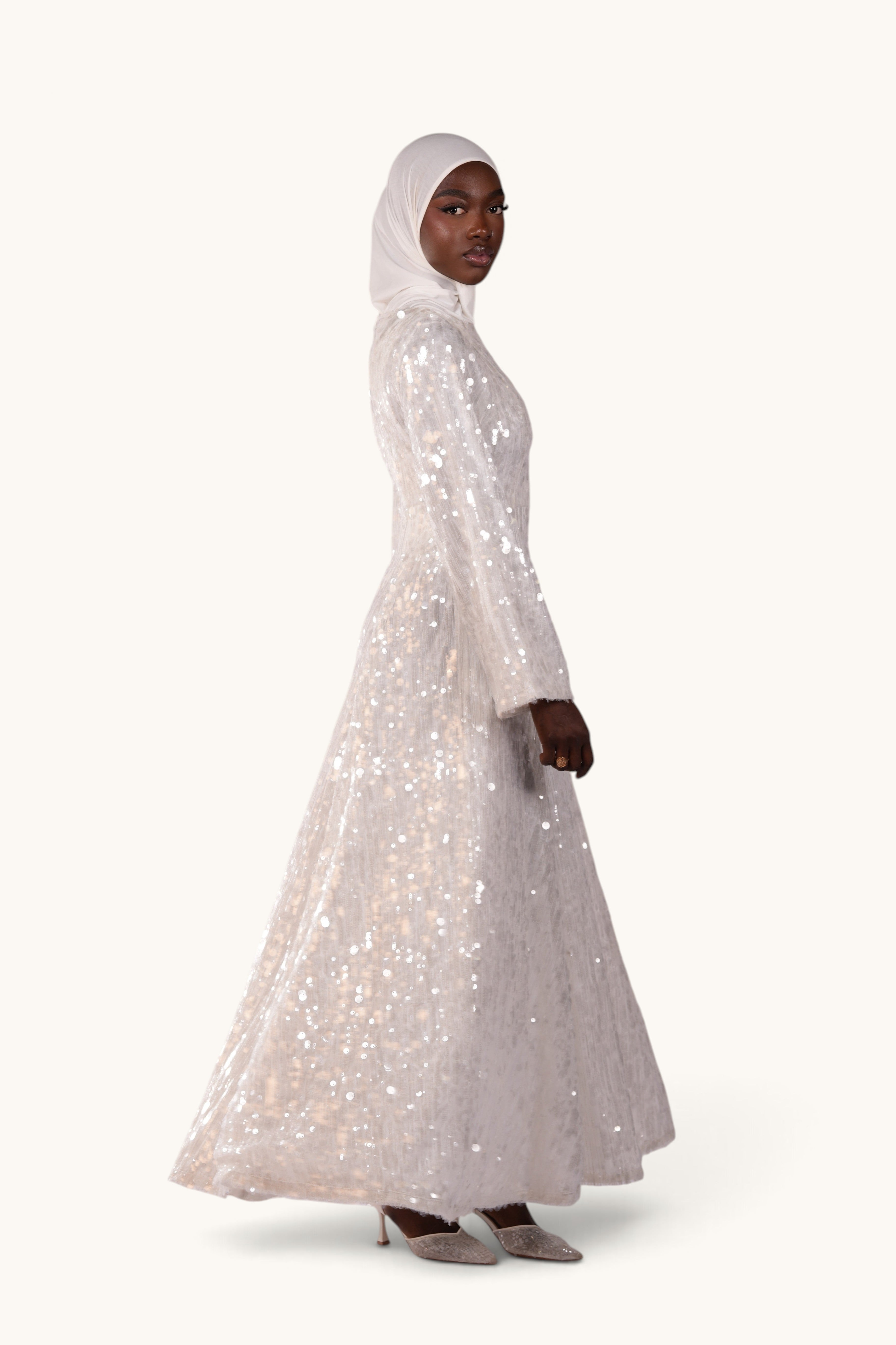 LOSYANA Formentera white sequin A-line evening dress with trumpet sleeves worn by a model in a hijab