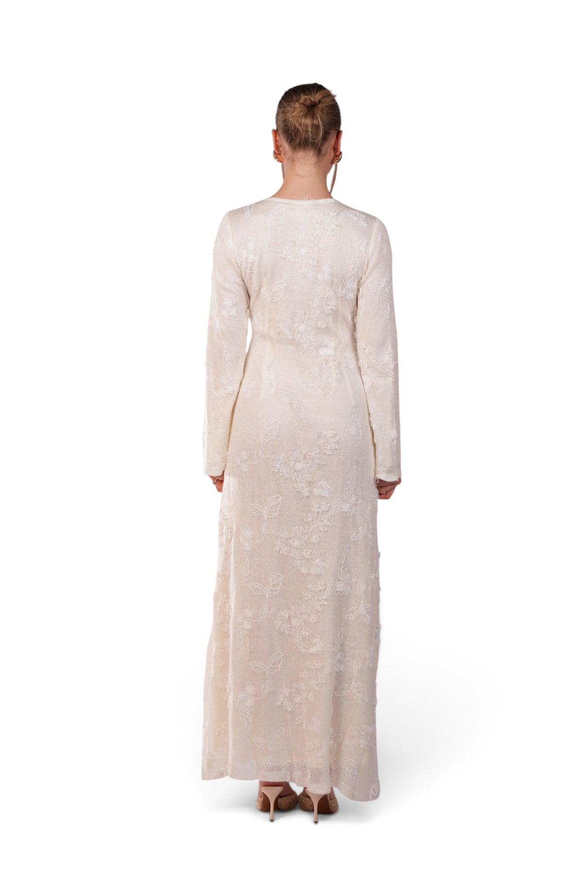 LOSYANA Fuerteventura elegant cream lace maxi dress with long trumpet sleeves worn by a model, back view.