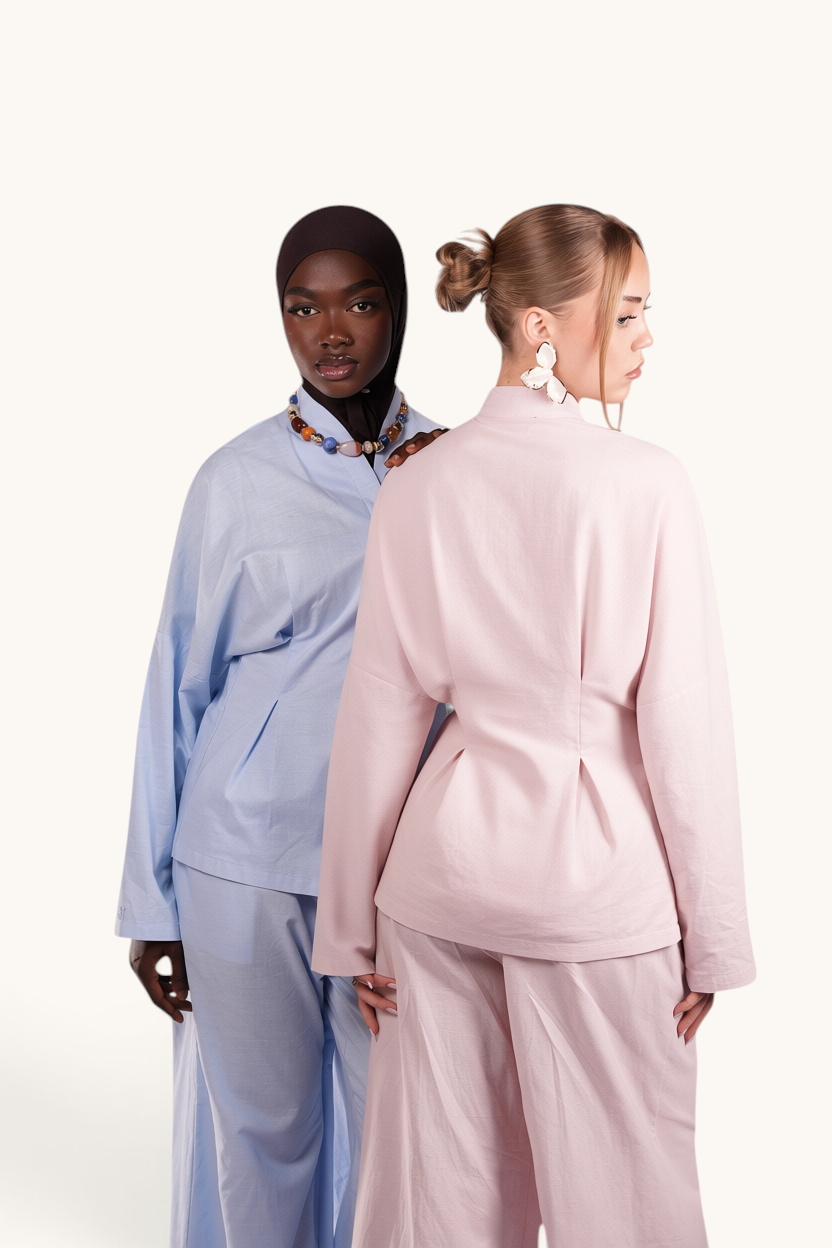 Two models wearing LOSYANA Gran Canaria linen two-piece sets in light blue and almond with trumpet sleeves.