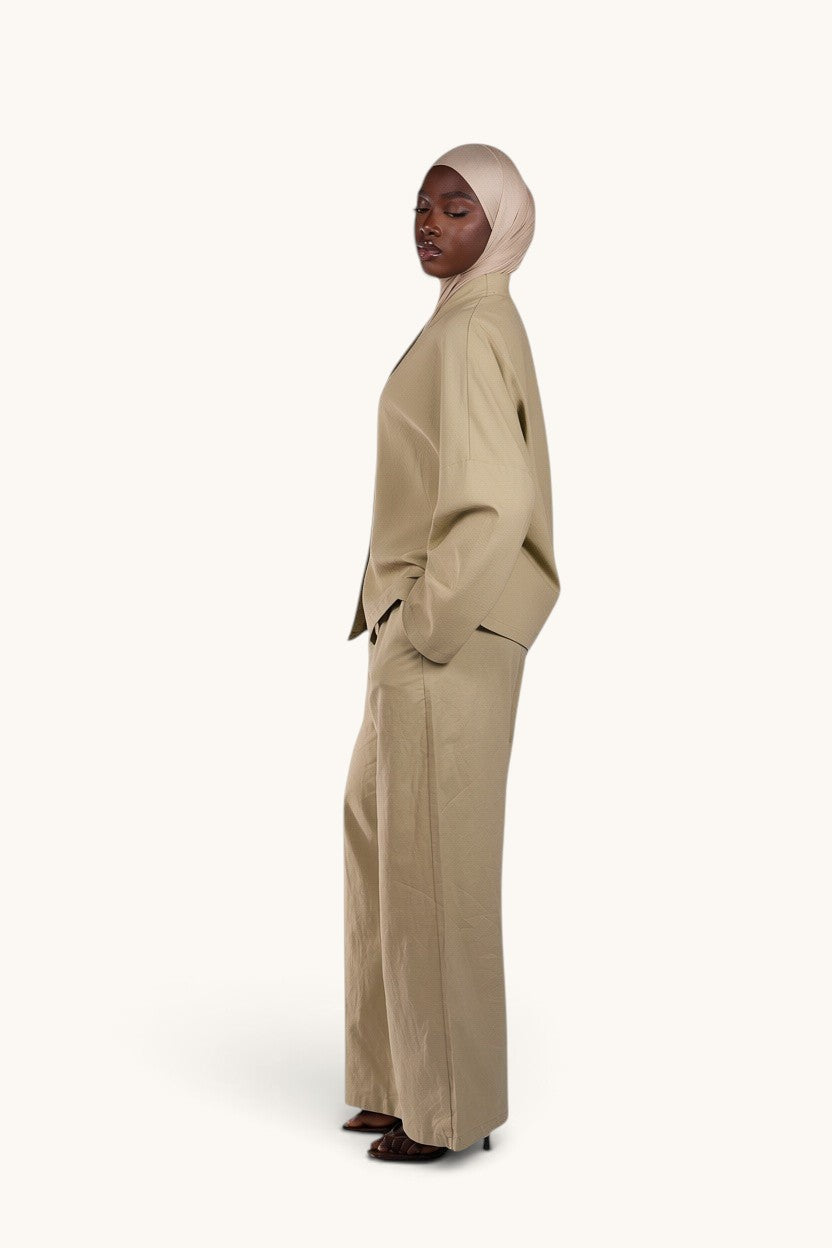 LOSYANA Gran Canaria pistachio linen two-piece set with wide-leg trousers and trumpet sleeve top on a model