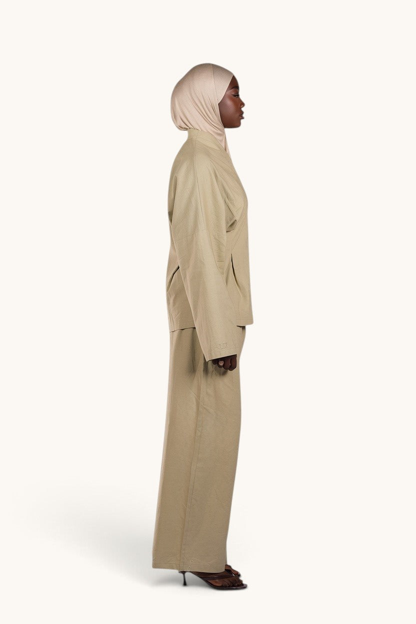 LOSYANA Gran Canaria pistachio linen two-piece set with wide-leg trousers and trumpet sleeve top on a model