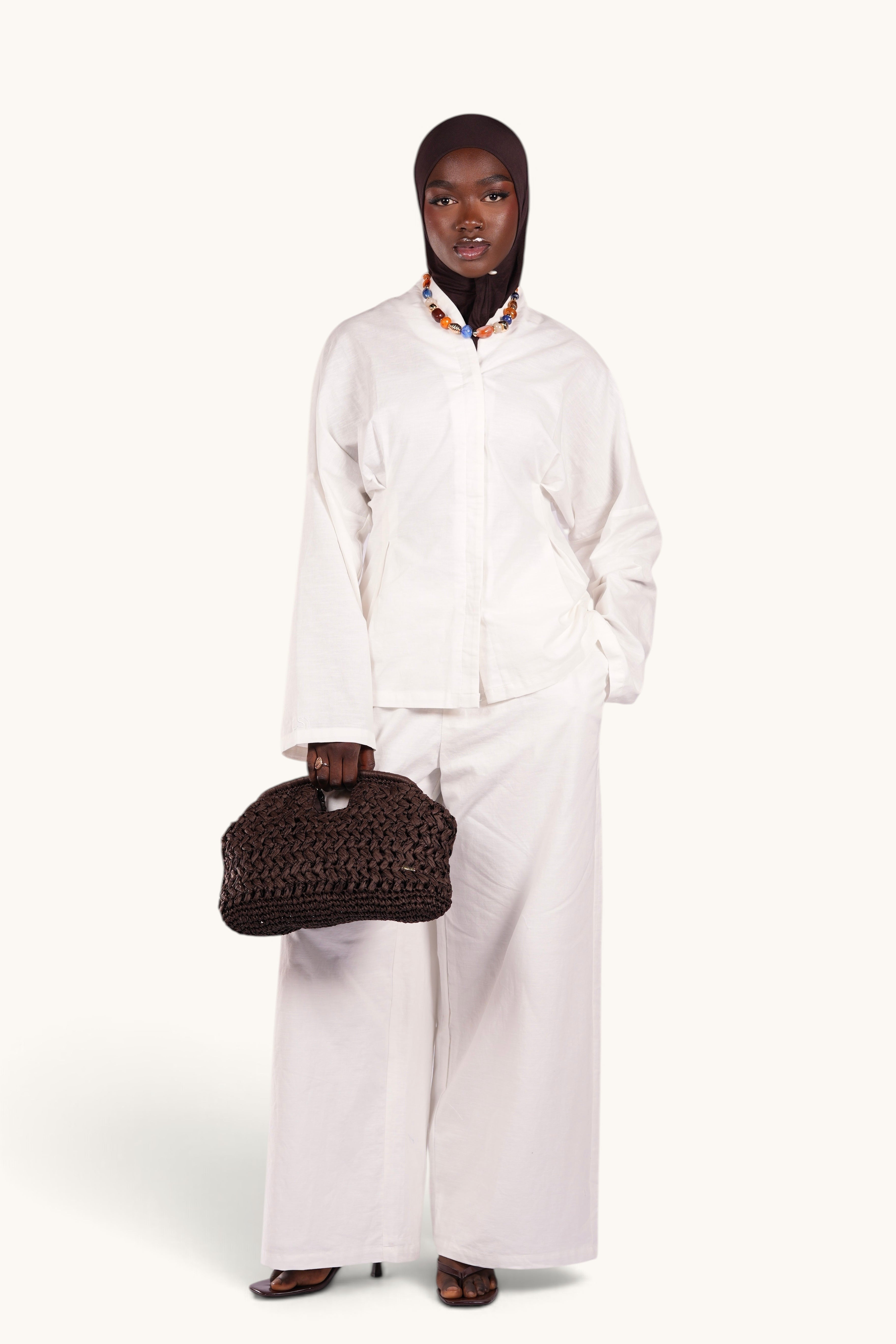 LOSYANA Gran Canaria white linen two-piece set with wide-leg trousers and trumpet sleeve top on a model