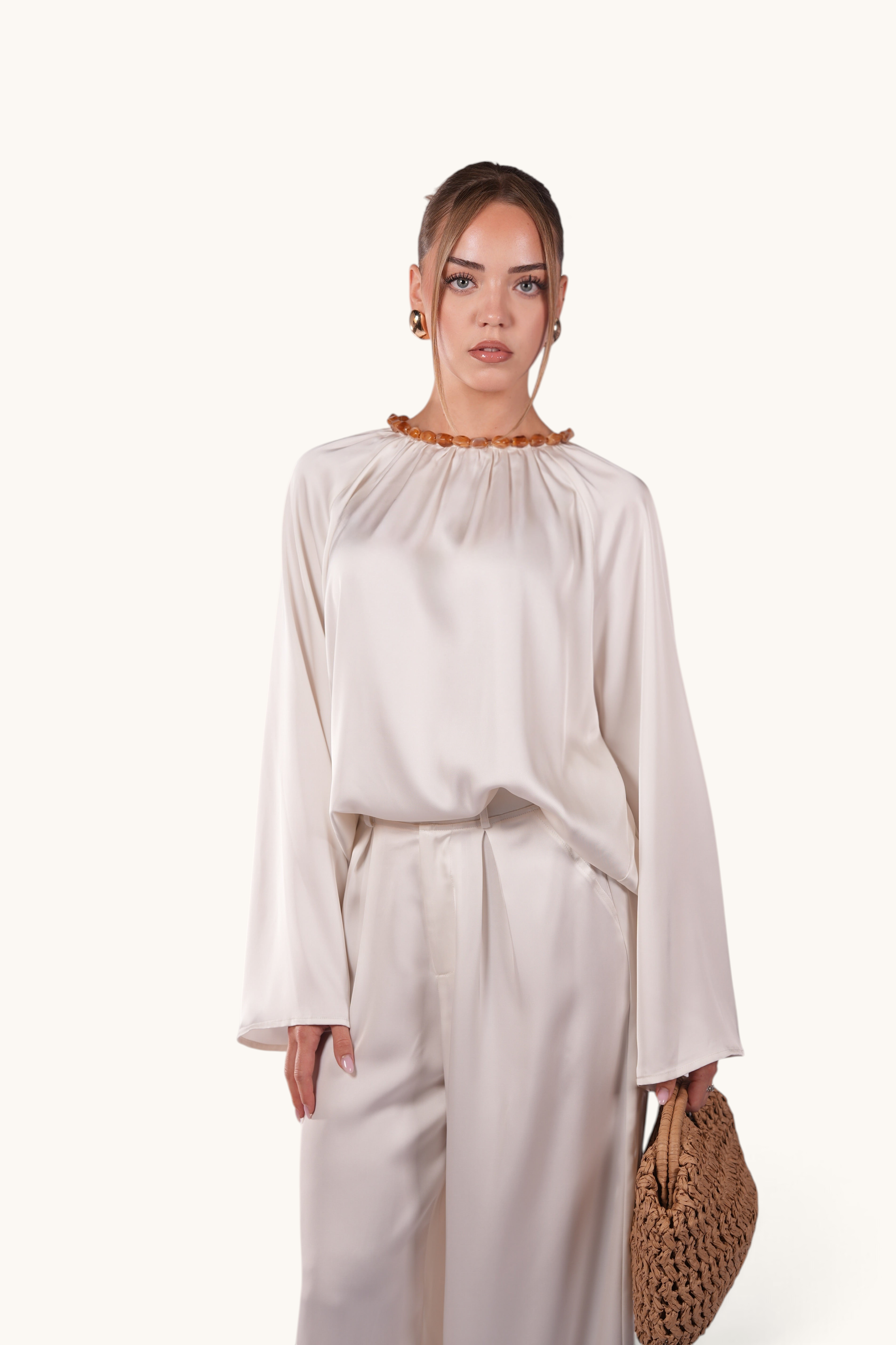 LOSYANA La Marina pearl white satin two-piece set with wide-leg trousers and a top featuring an acrylic stone collar.