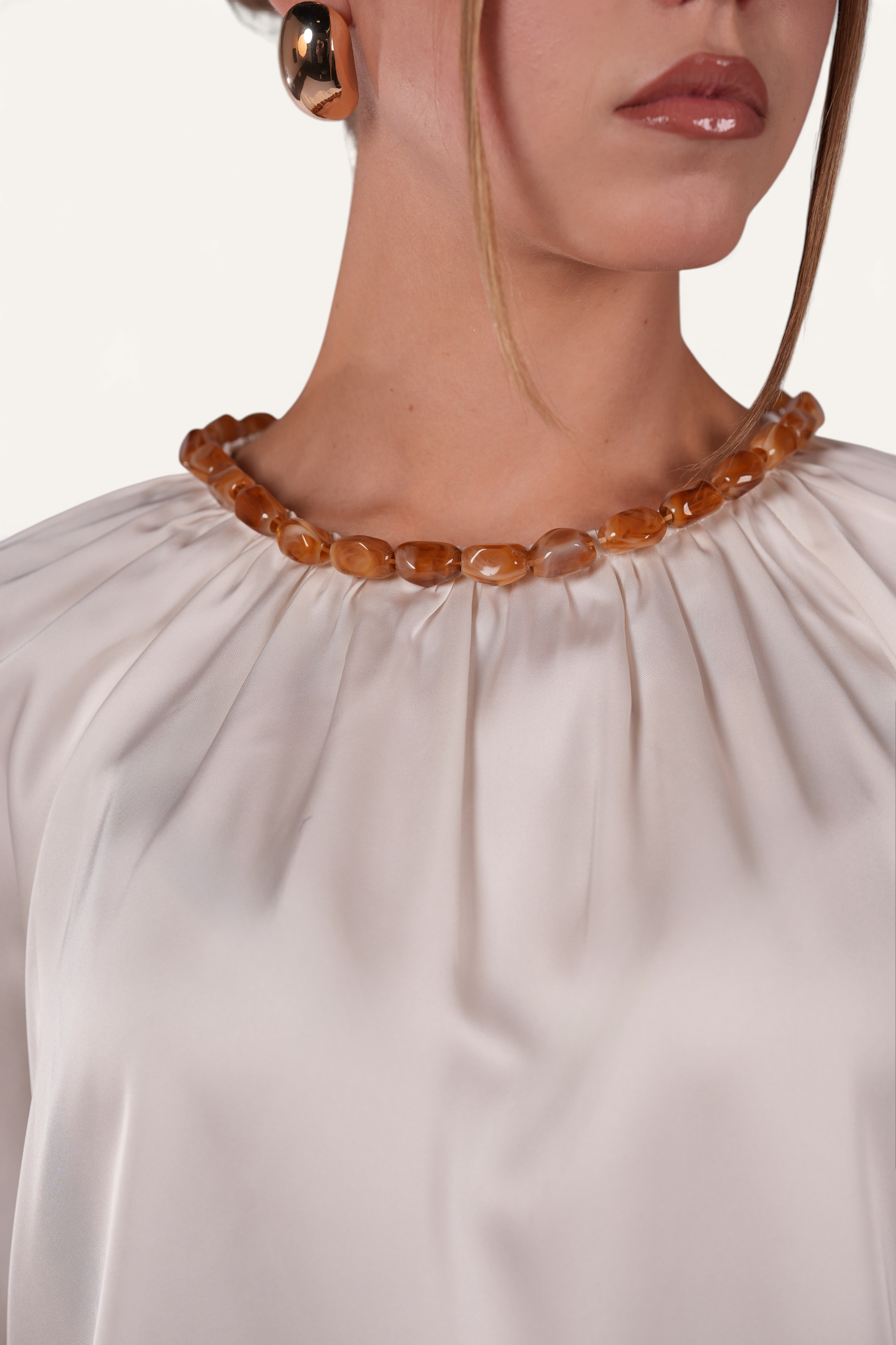 LOSYANA La Marina pearl white satin top featuring a decorative amber-toned acrylic stone collar detail
