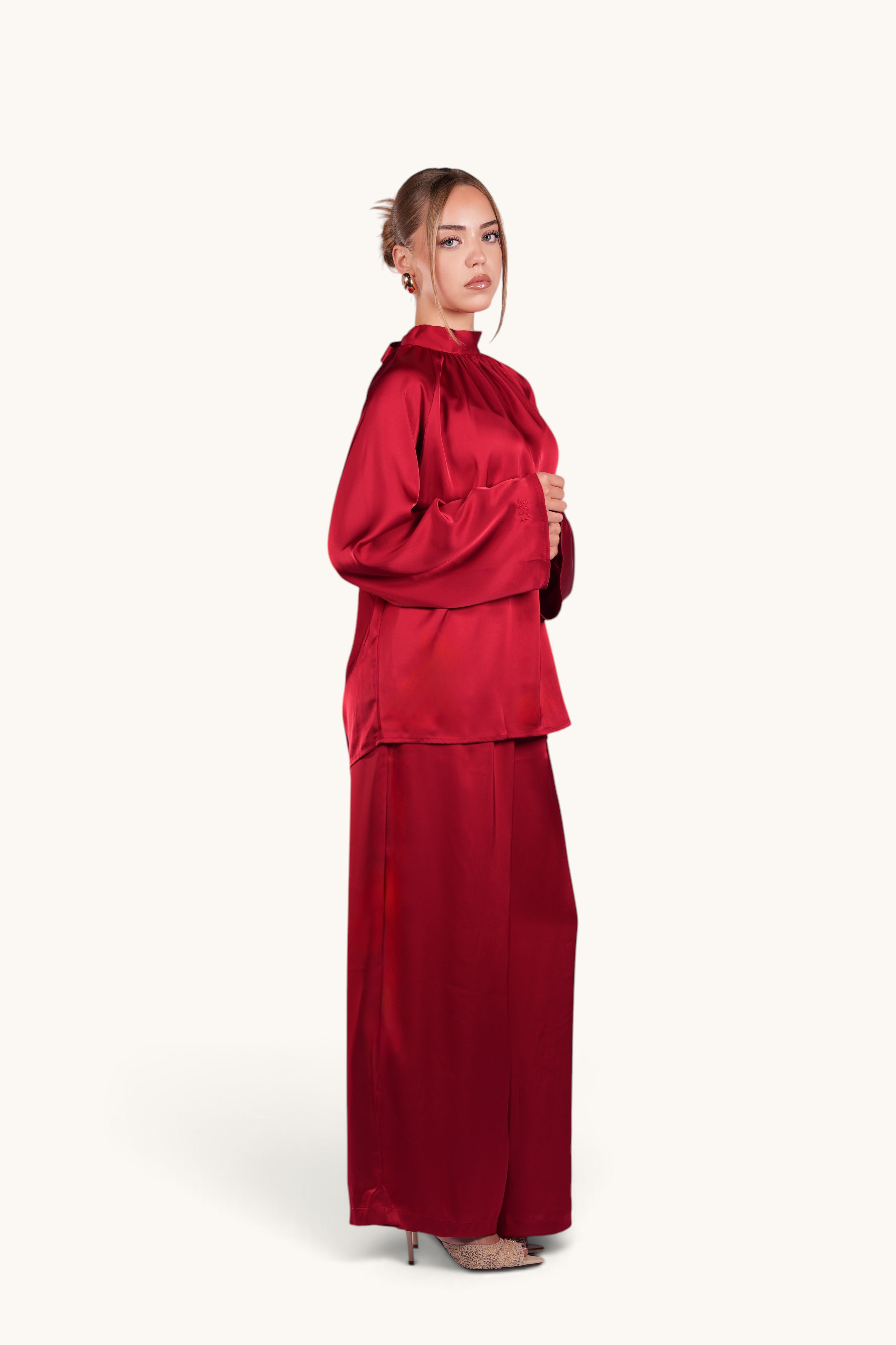 LOSYANA La Palma red satin two-piece set with high collar top and wide-leg trousers worn by a model