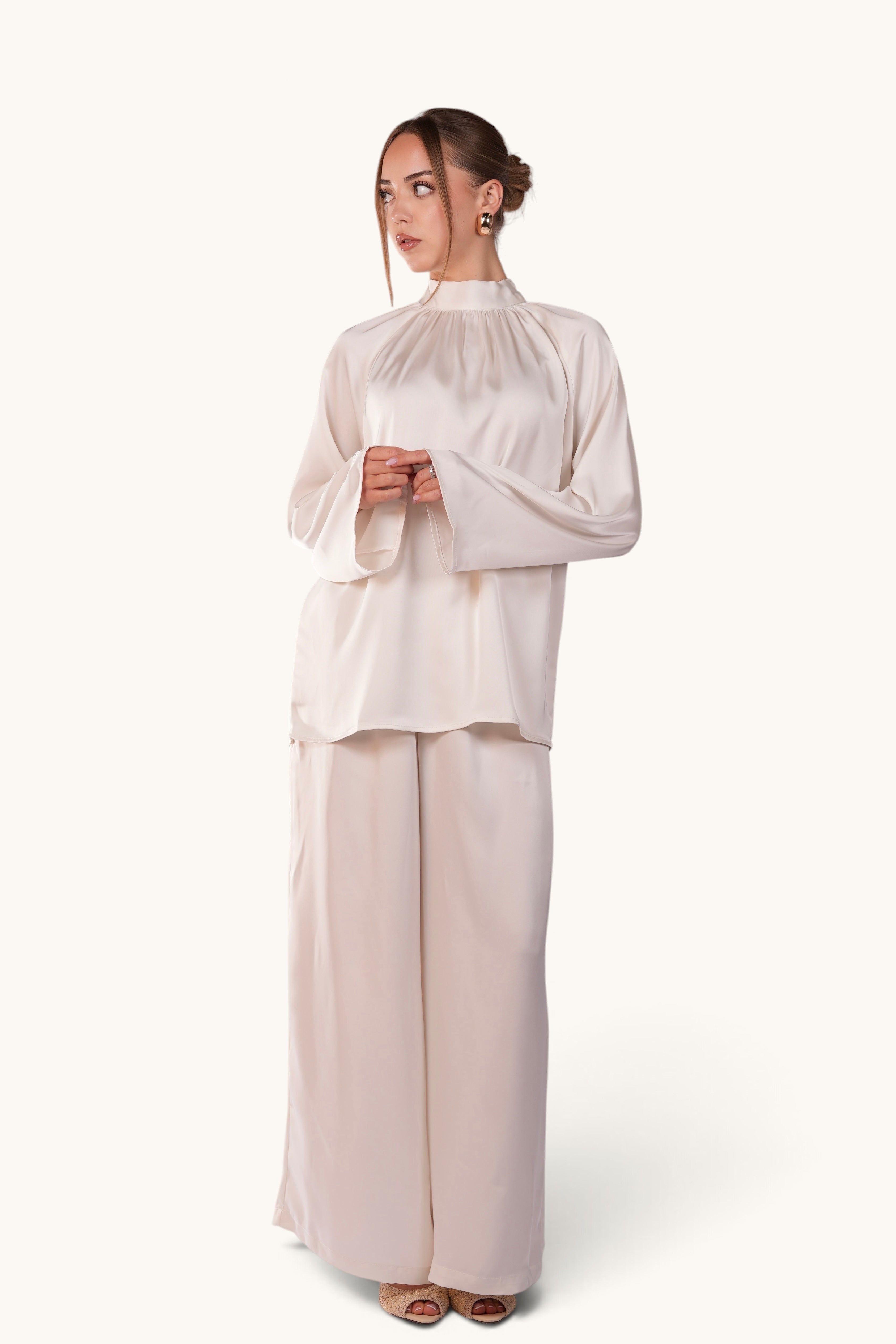 LOSYANA La Palma white satin two-piece set featuring a high-neck top with back tie and wide-leg trousers on a model