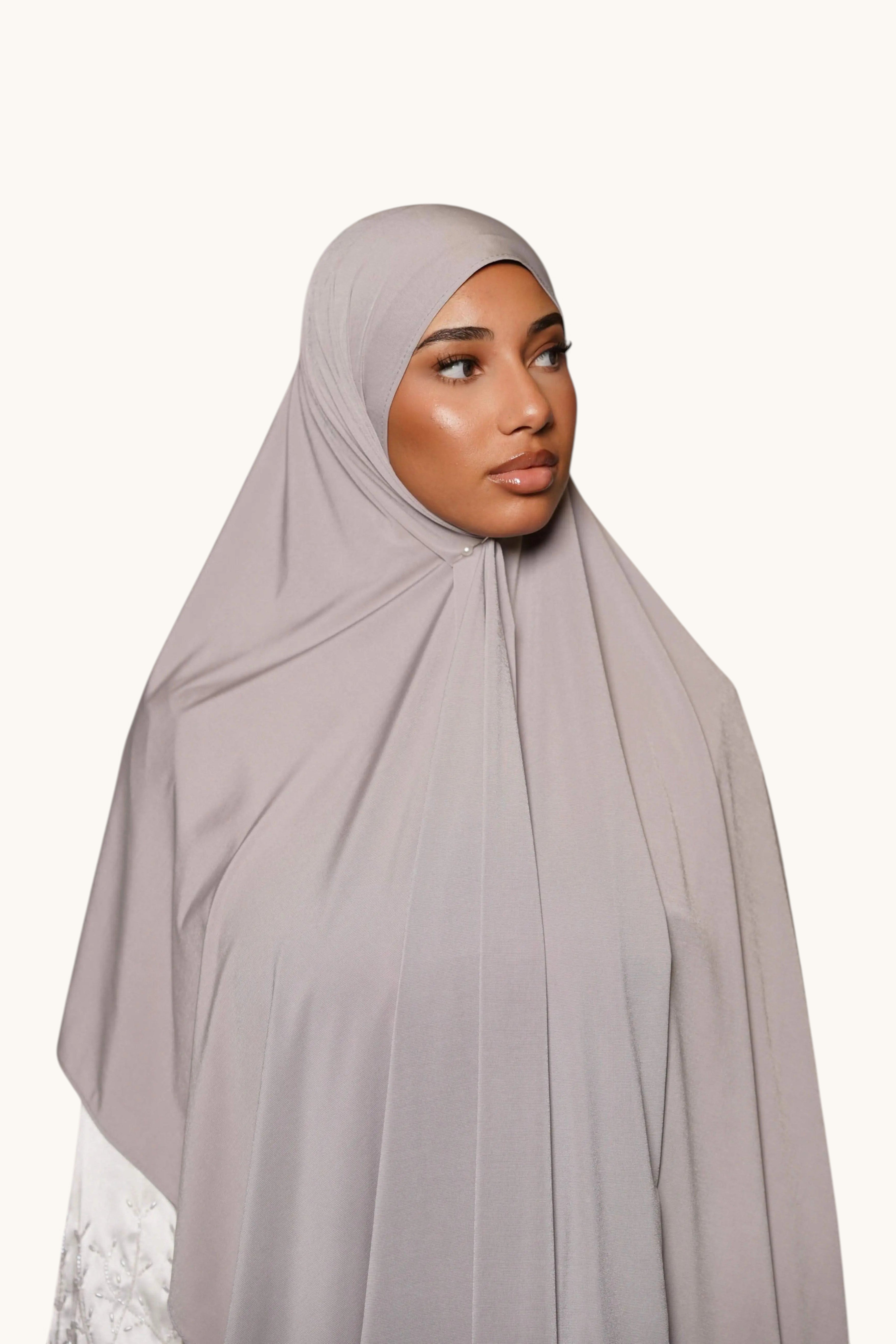 LOSYANA light grey satin jersey hijab worn by a model, featuring a smooth, opaque, and non-slip fabric drape.