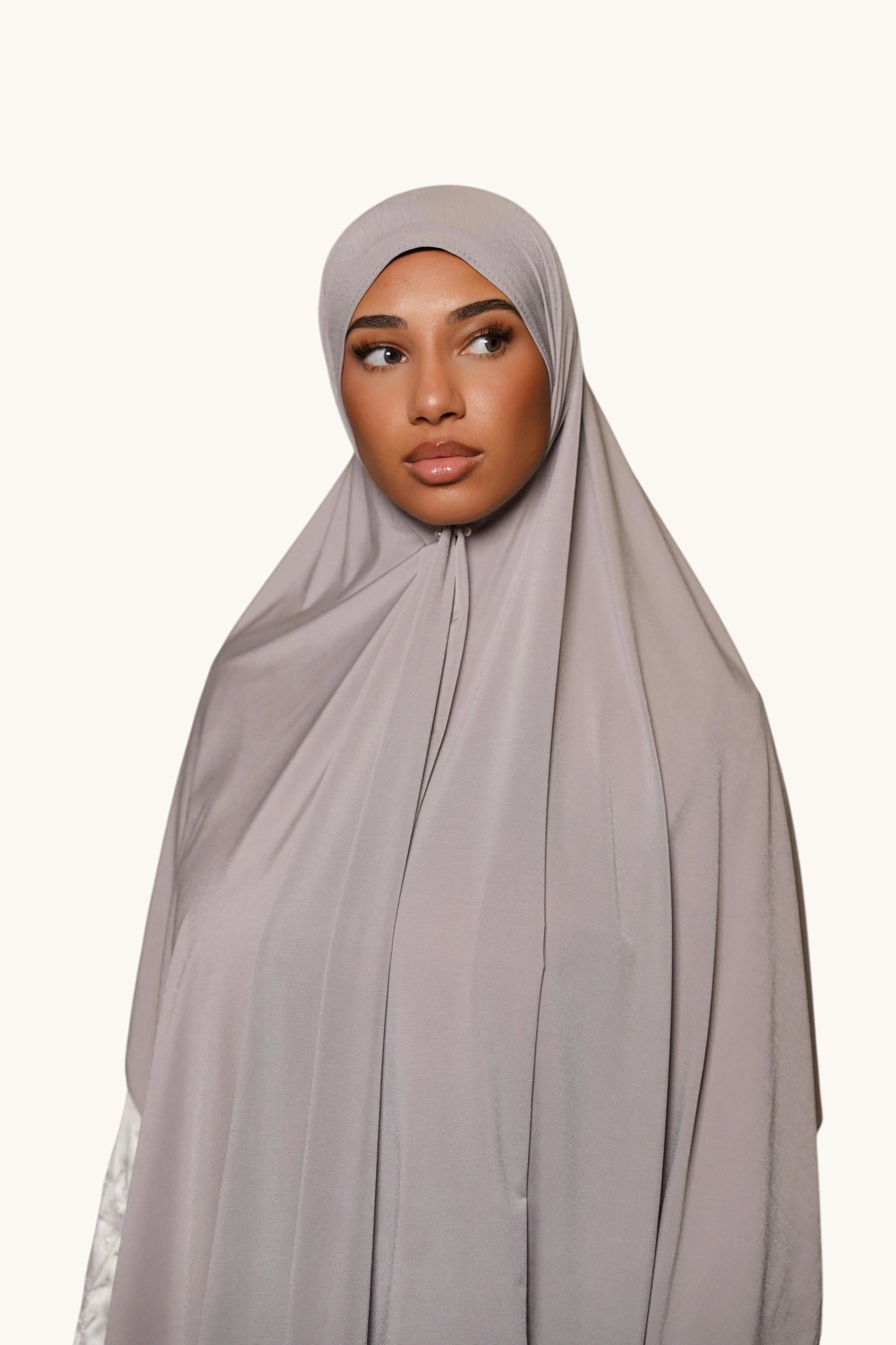 LOSYANA light grey satin jersey hijab worn by a model, featuring a smooth, opaque, and non-slip fabric drape.