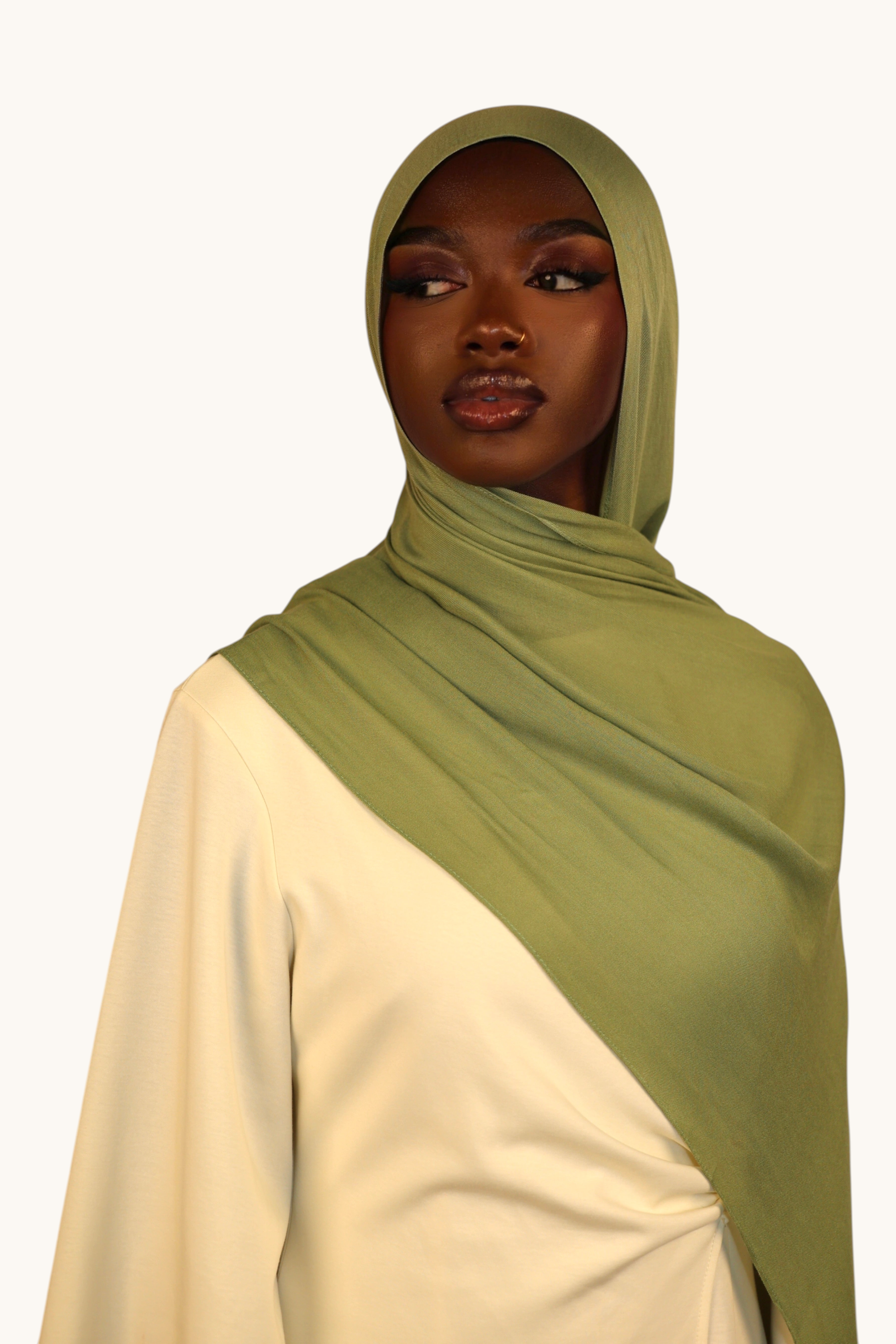 Model wearing a lightweight light olive green LOSYANA modal hijab with a matching undercap for an elegant look.