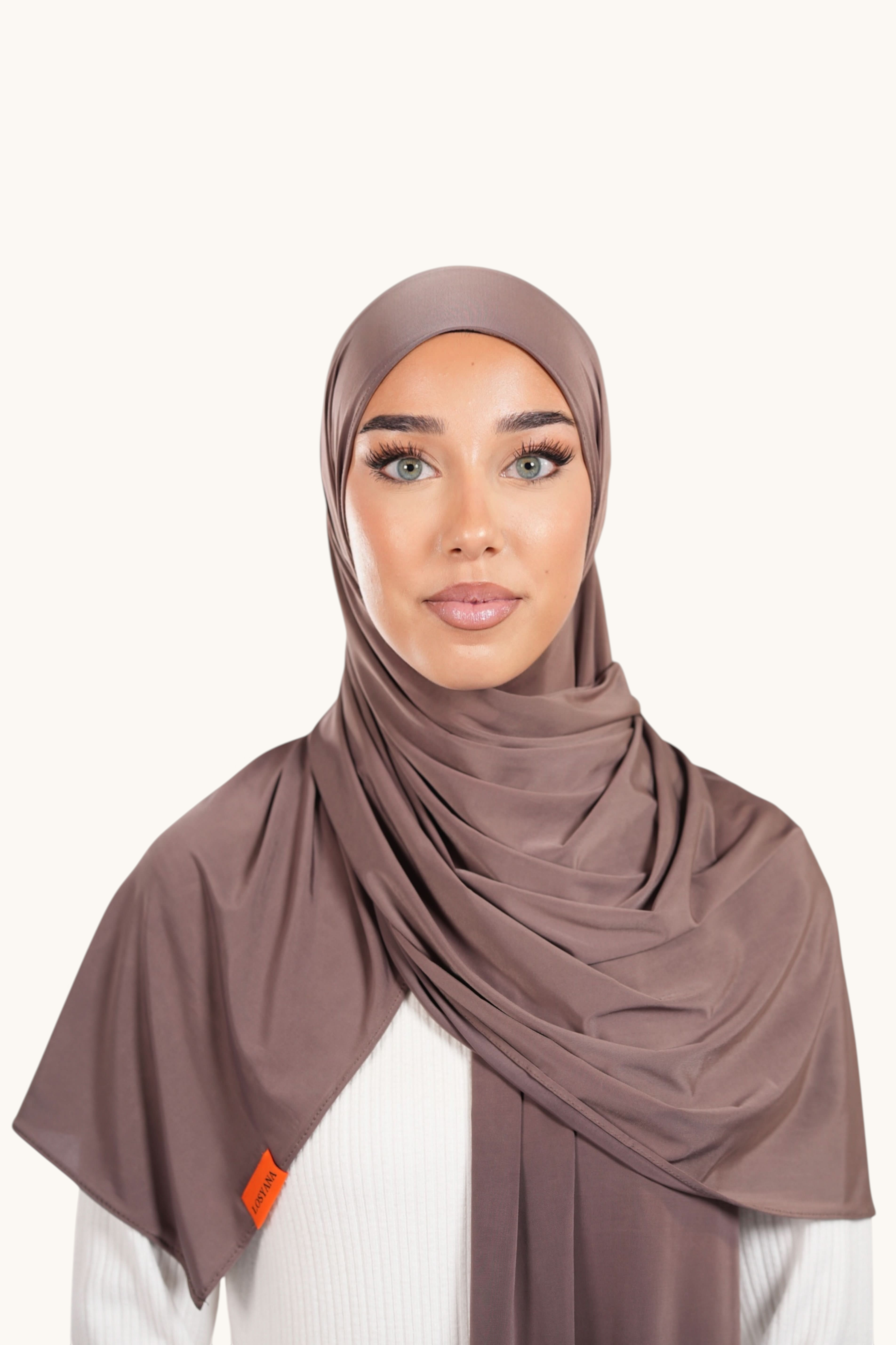 LOSYANA Liquid Jersey hijab in coffee brown, featuring a lightweight, slightly glossy fabric draped elegantly.