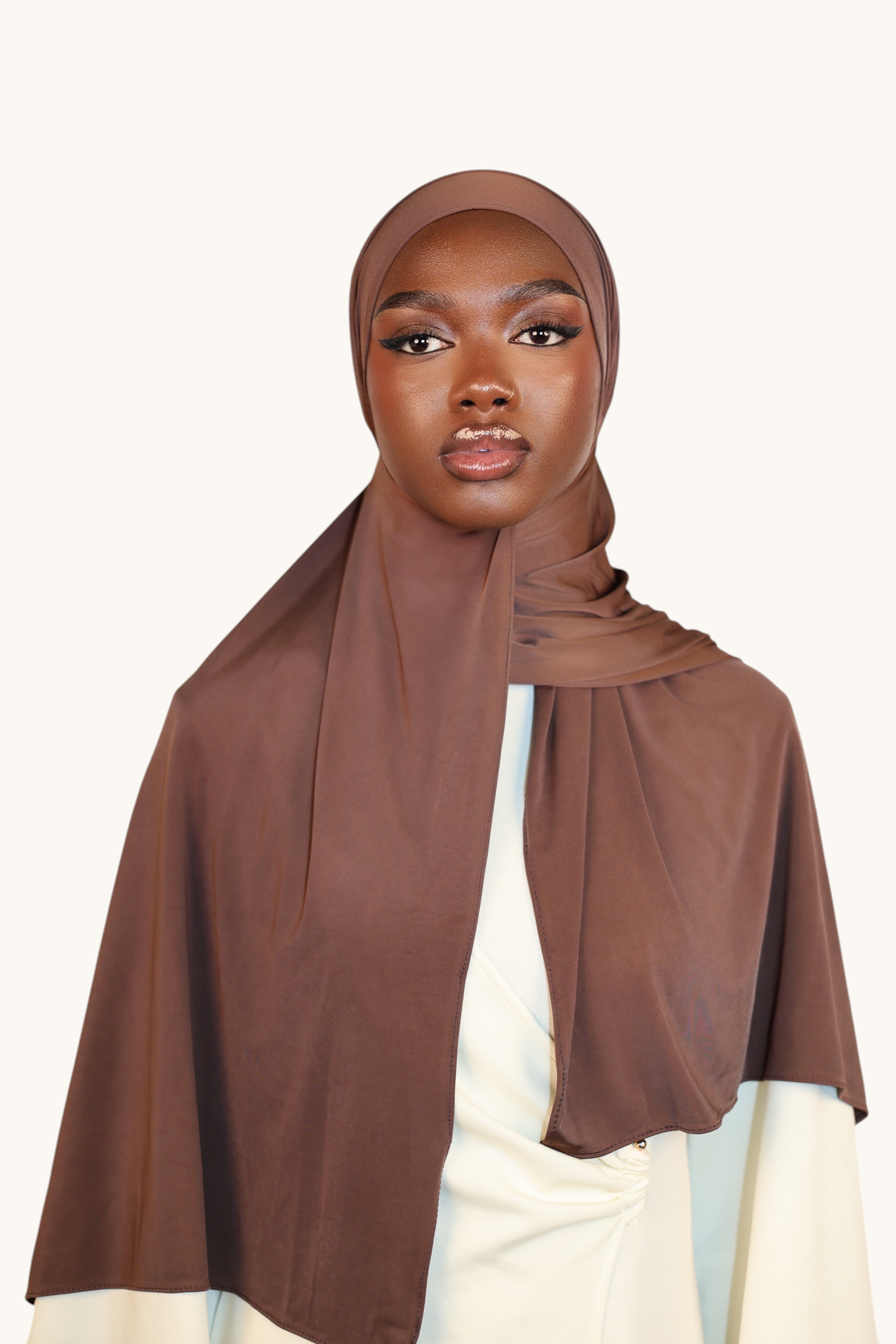 Model wearing a LOSYANA Liquid Jersey hijab in burnt sugar, featuring a lightweight, elegant, and subtle sheen.