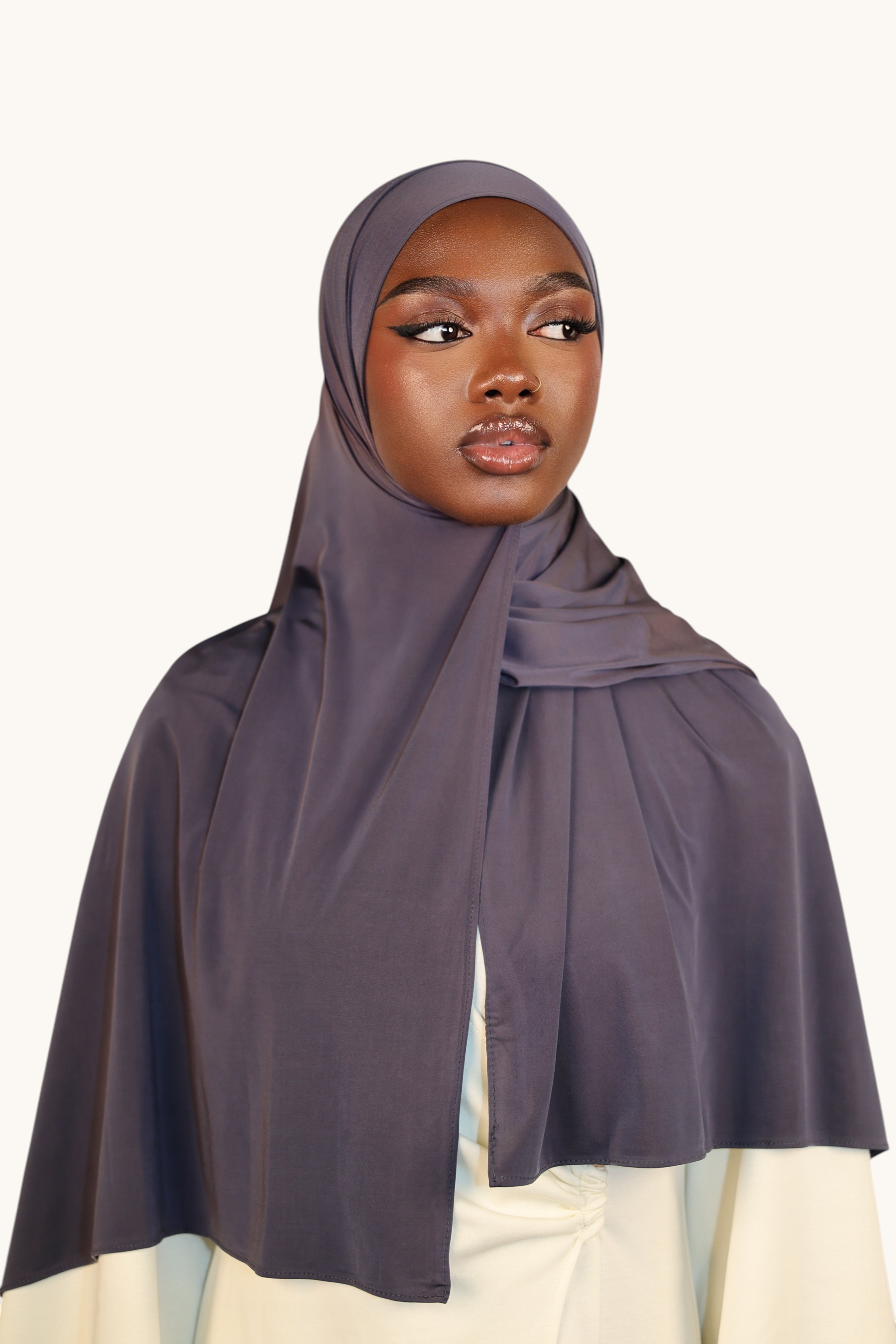LOSYANA Liquid Jersey hijab in dusty blue worn by a model, featuring a lightweight, elegant, and breathable fabric.