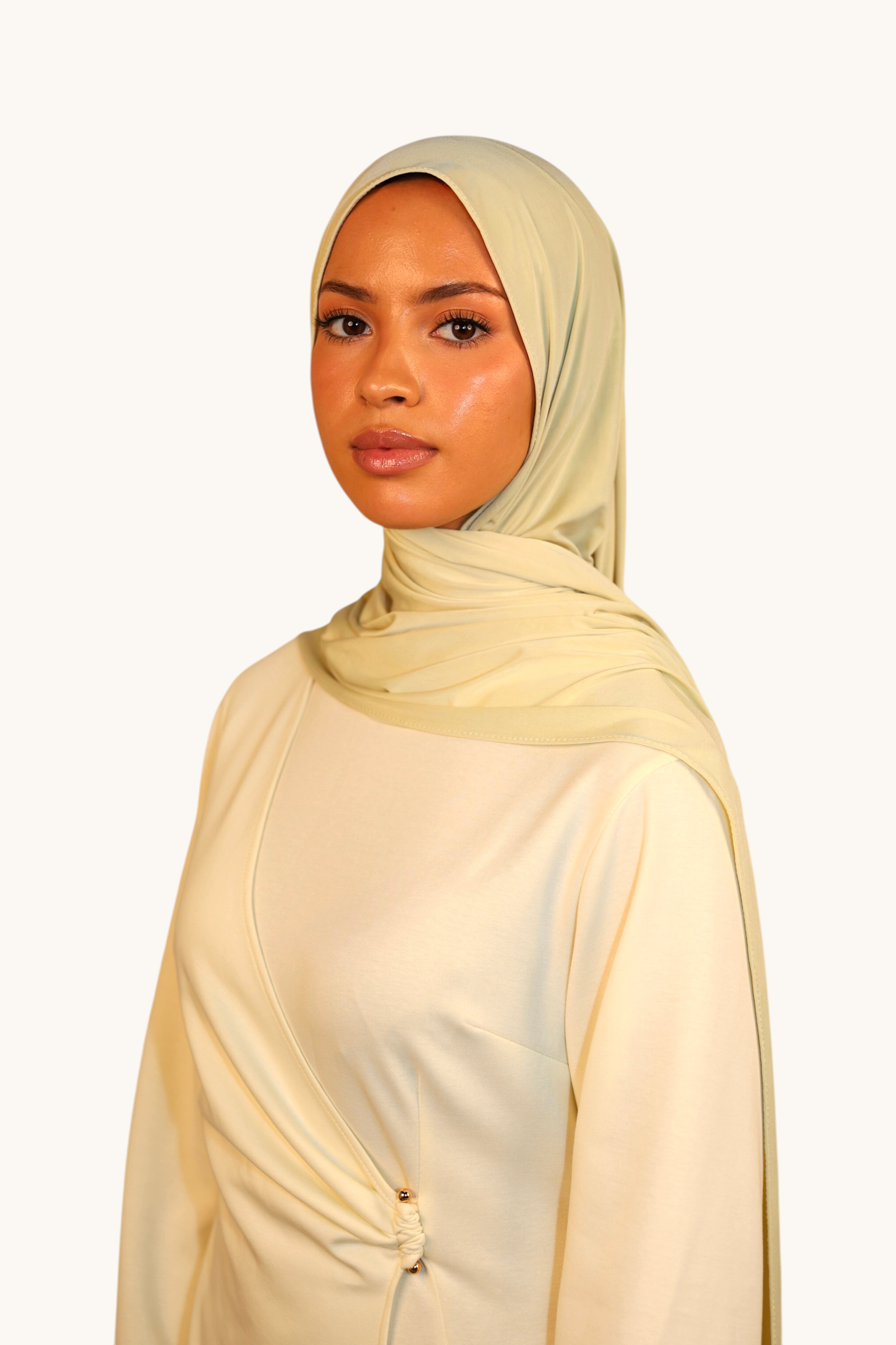 LOSYANA Liquid Jersey hijab in light lime, worn by a model, featuring a soft, breathable, and slightly glossy fabric.