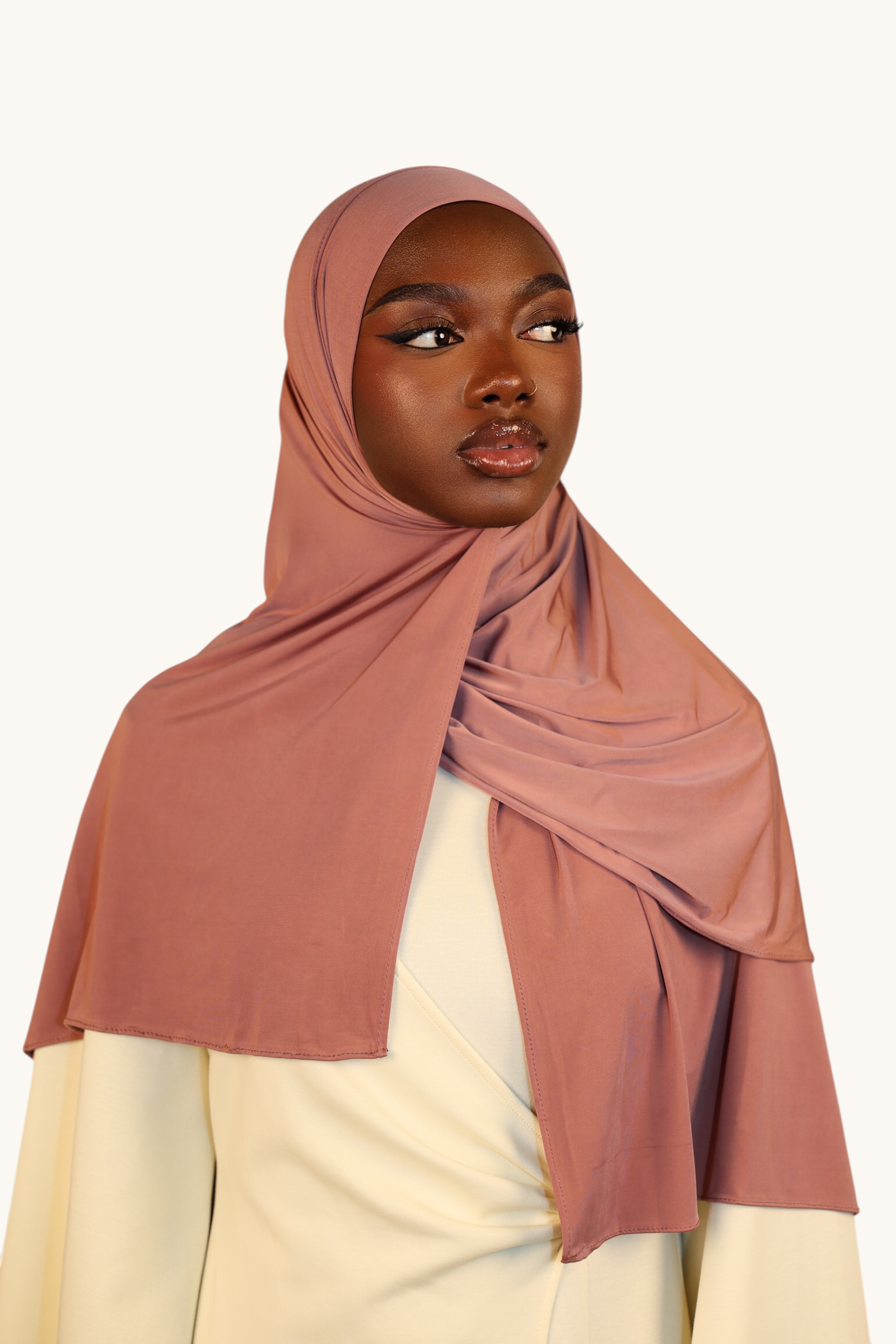 Model wearing a LOSYANA Liquid Jersey hijab in rosewood, featuring a lightweight, soft, and slightly glossy finish.