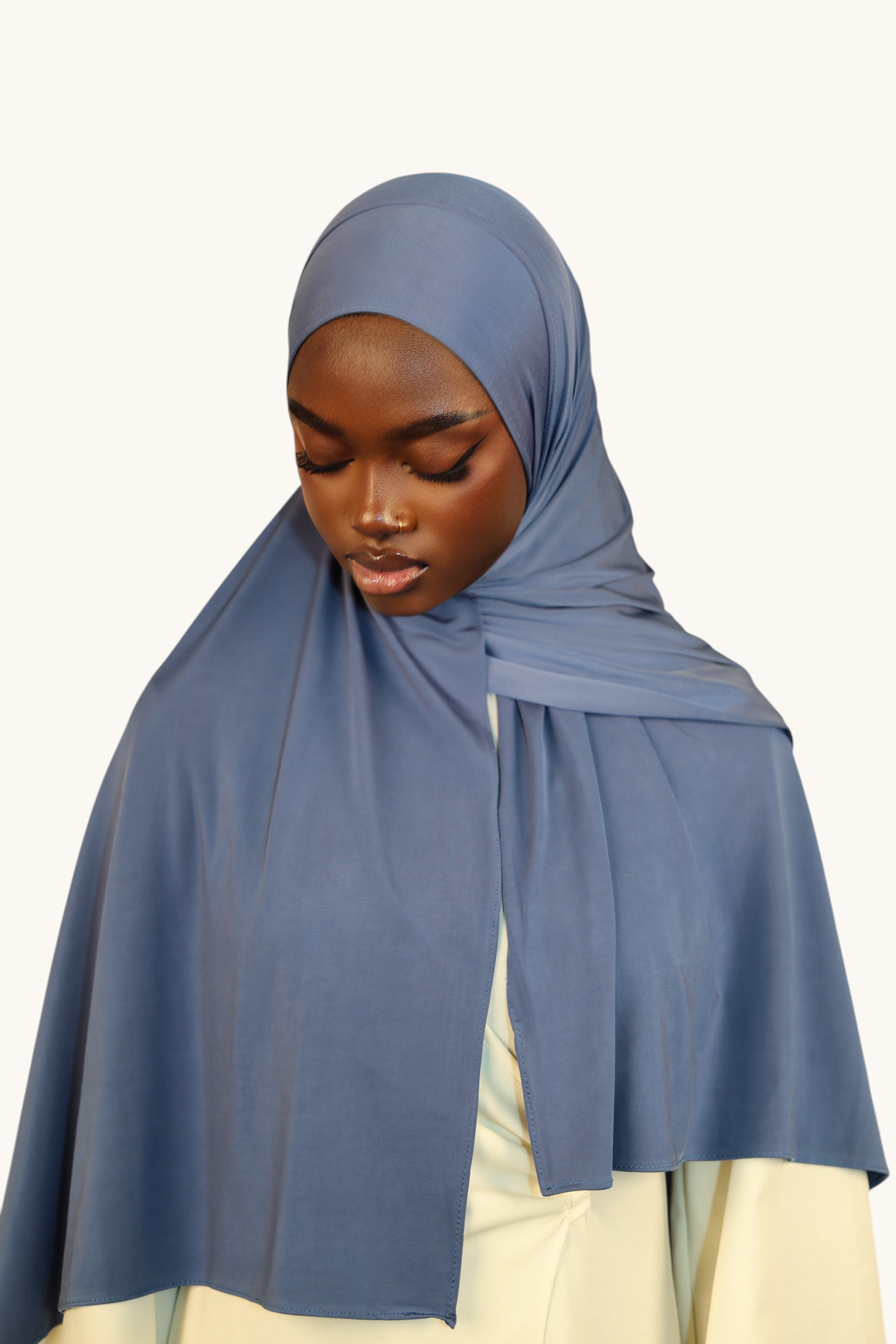 LOSYANA Liquid Jersey hijab in ocean blue, featuring a lightweight, slightly glossy fabric on a model.