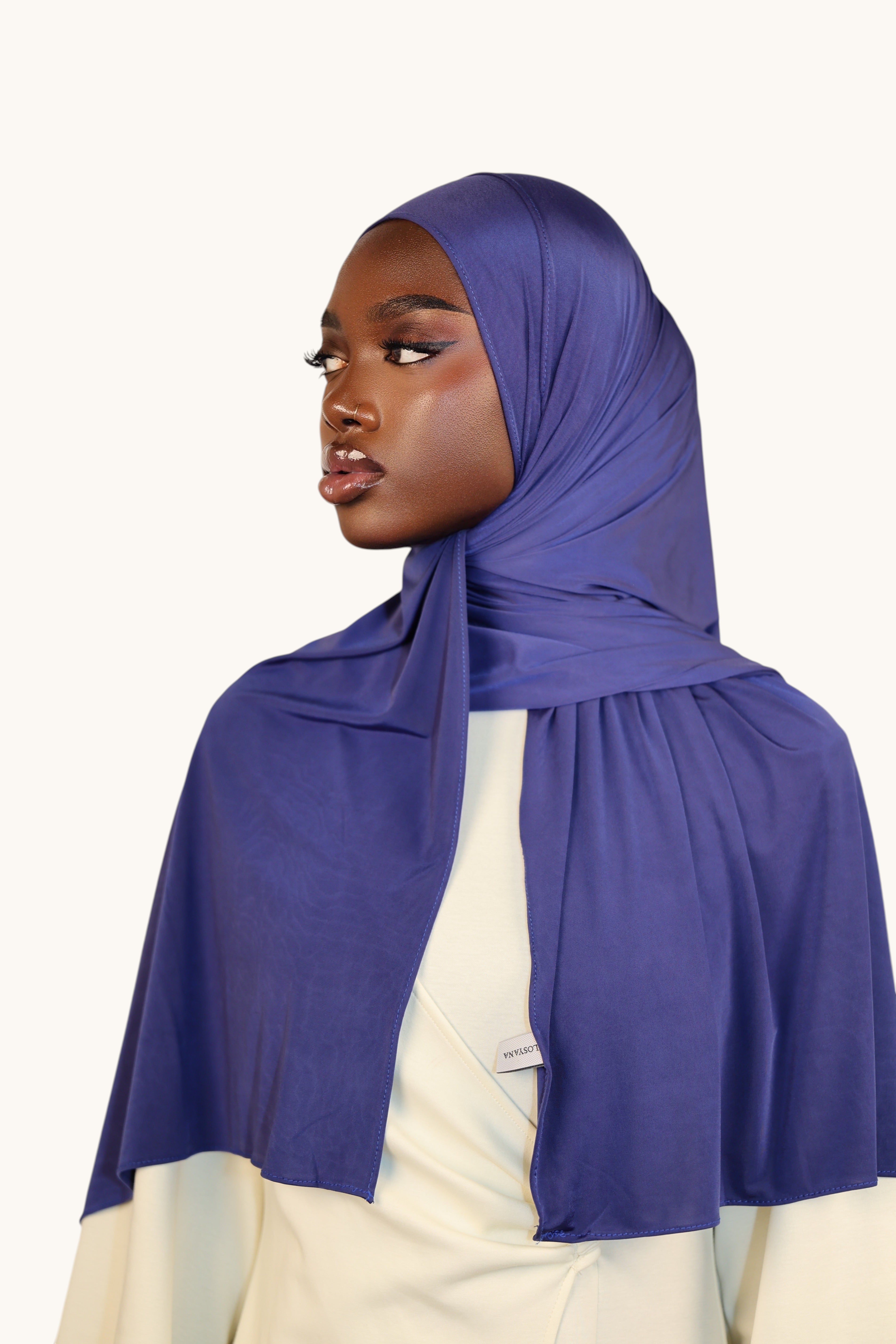 LOSYANA Liquid Jersey hijab in sapphire blue worn by a model, featuring a lightweight, elegant, and silky finish.