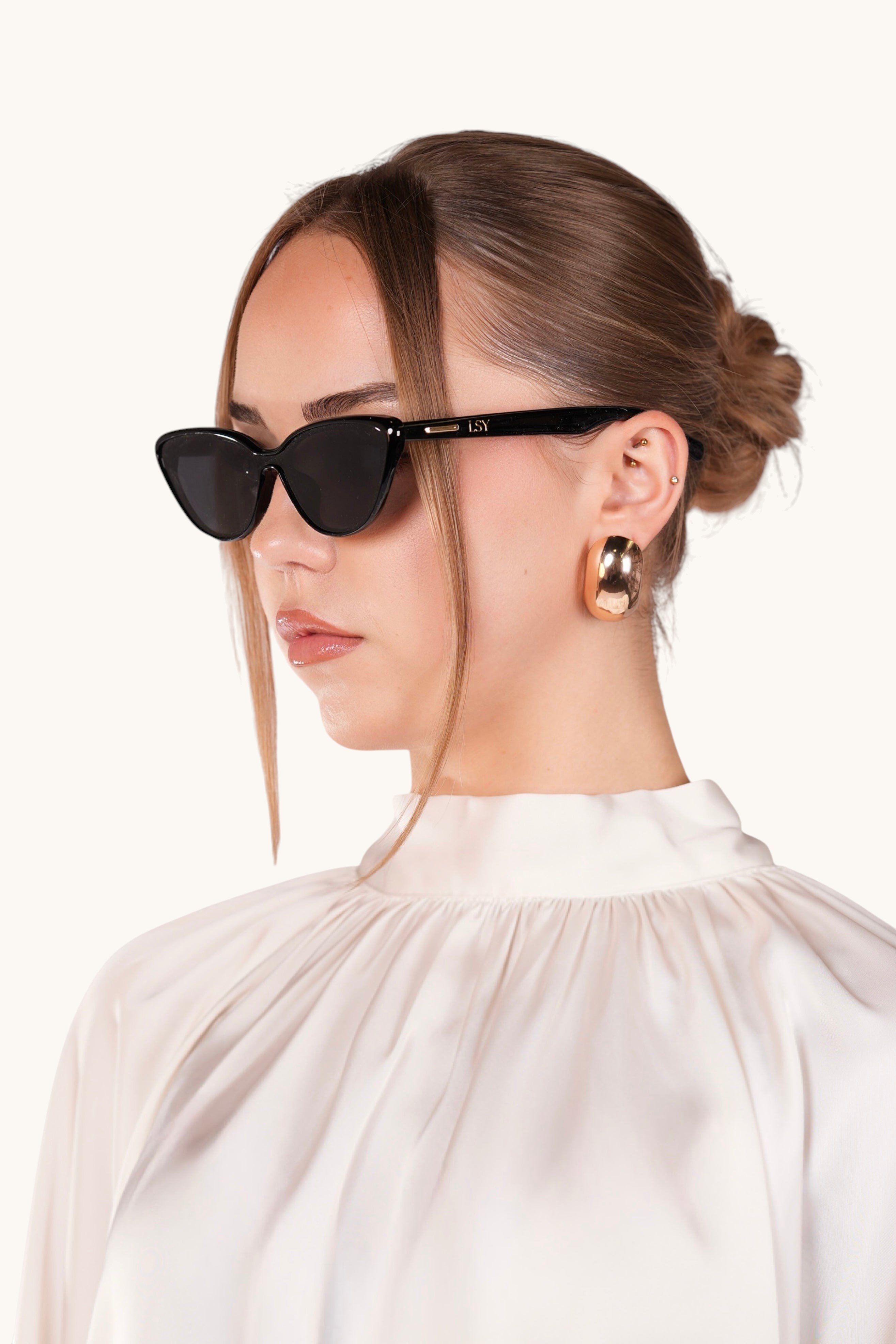 LOSYANA LSY sunglasses with black frames worn by a woman in a white blouse, providing 100% UVA and UVB protection.