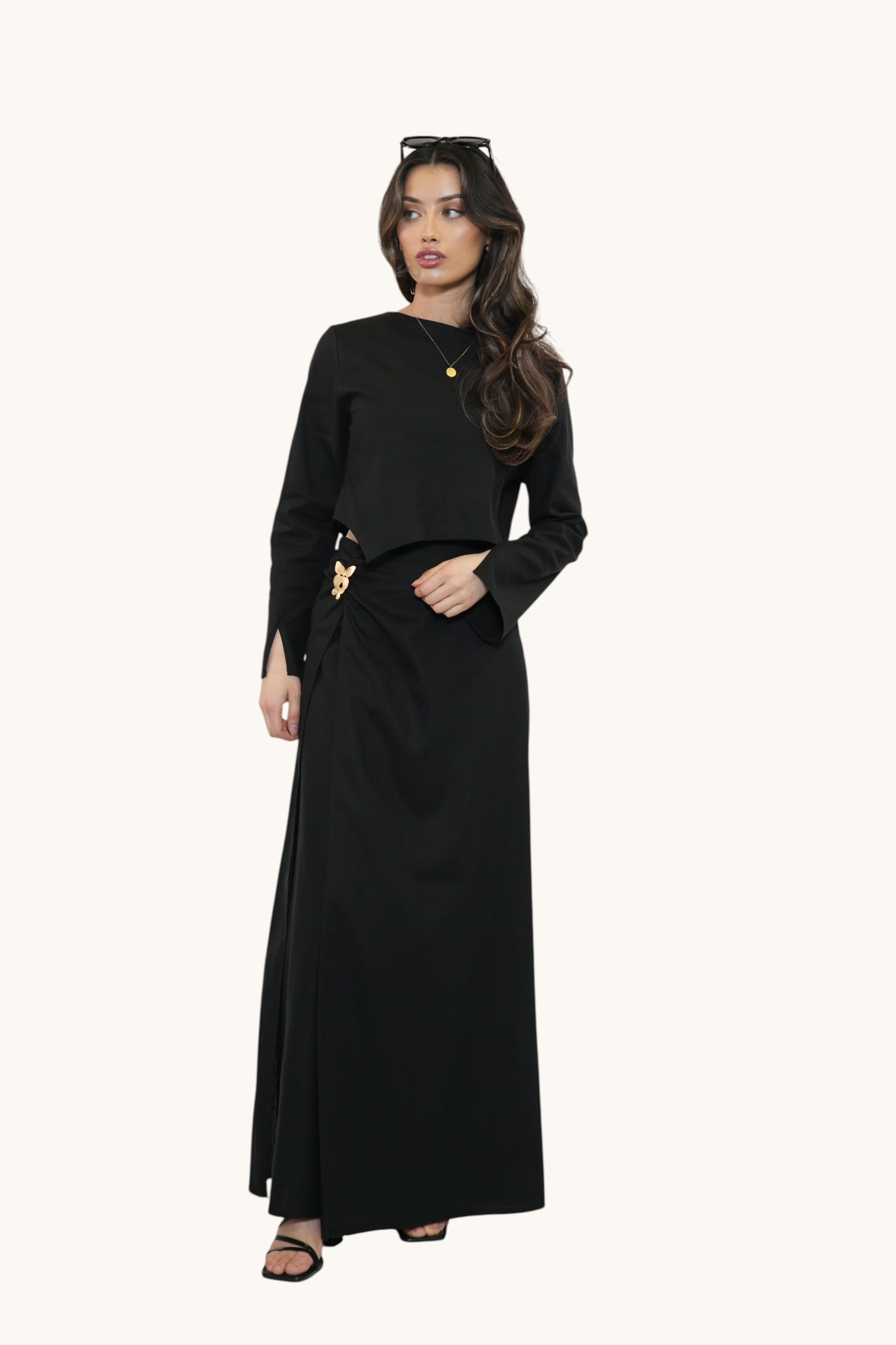 Model wearing a black LOSYANA Mediterrance Serenity Set featuring a long-sleeved top and a matching maxi skirt.