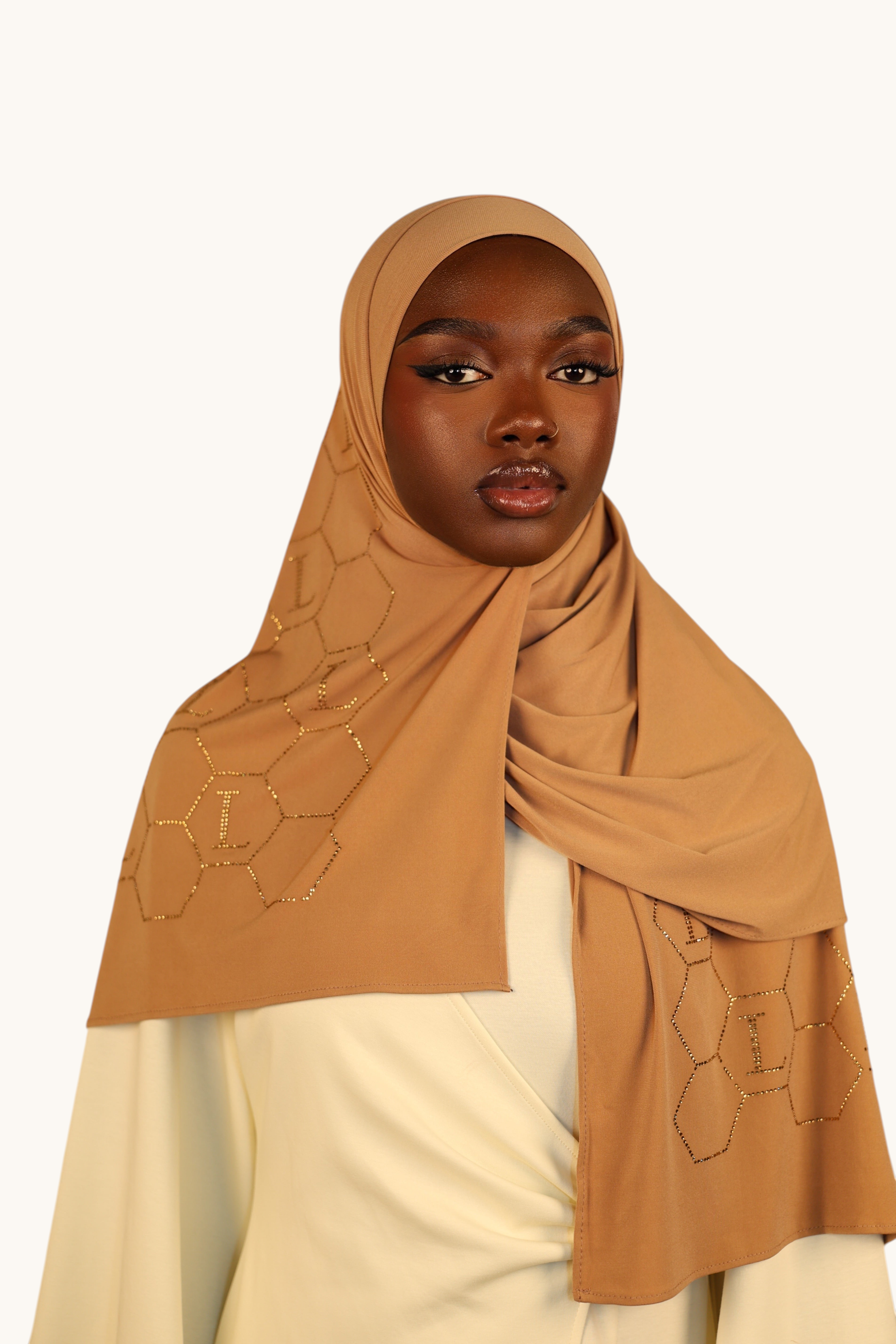 LOSYANA mustard premium jersey hijab with sparkling rhinestone L logo and geometric honeycomb pattern