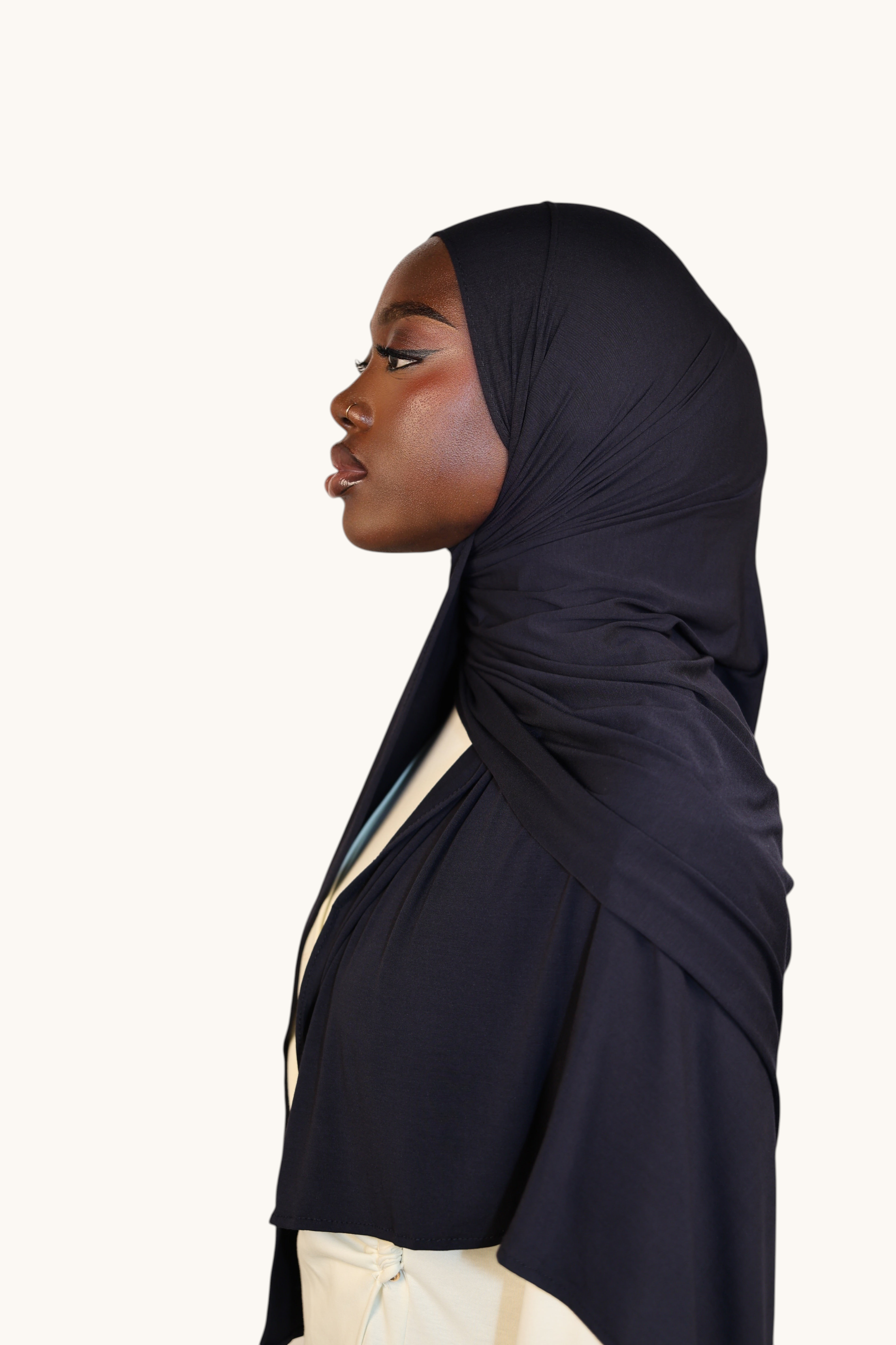 Model wearing a navy LOSYANA Vela Jersey hijab, showcasing the soft, lightweight fabric and elegant drape.
