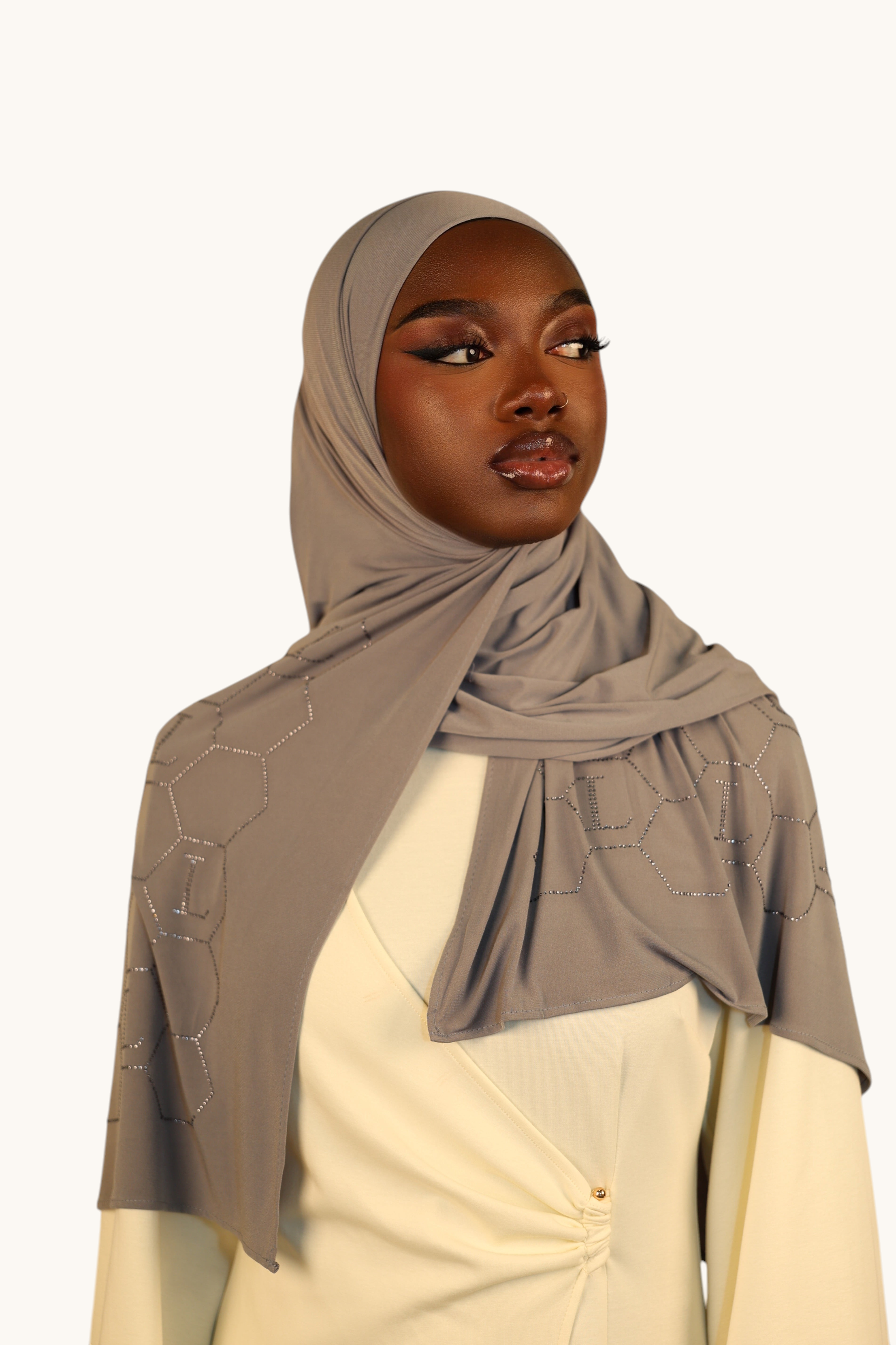LOSYANA nude grey premium jersey hijab with sparkling rhinestone L-pattern detail worn by a model