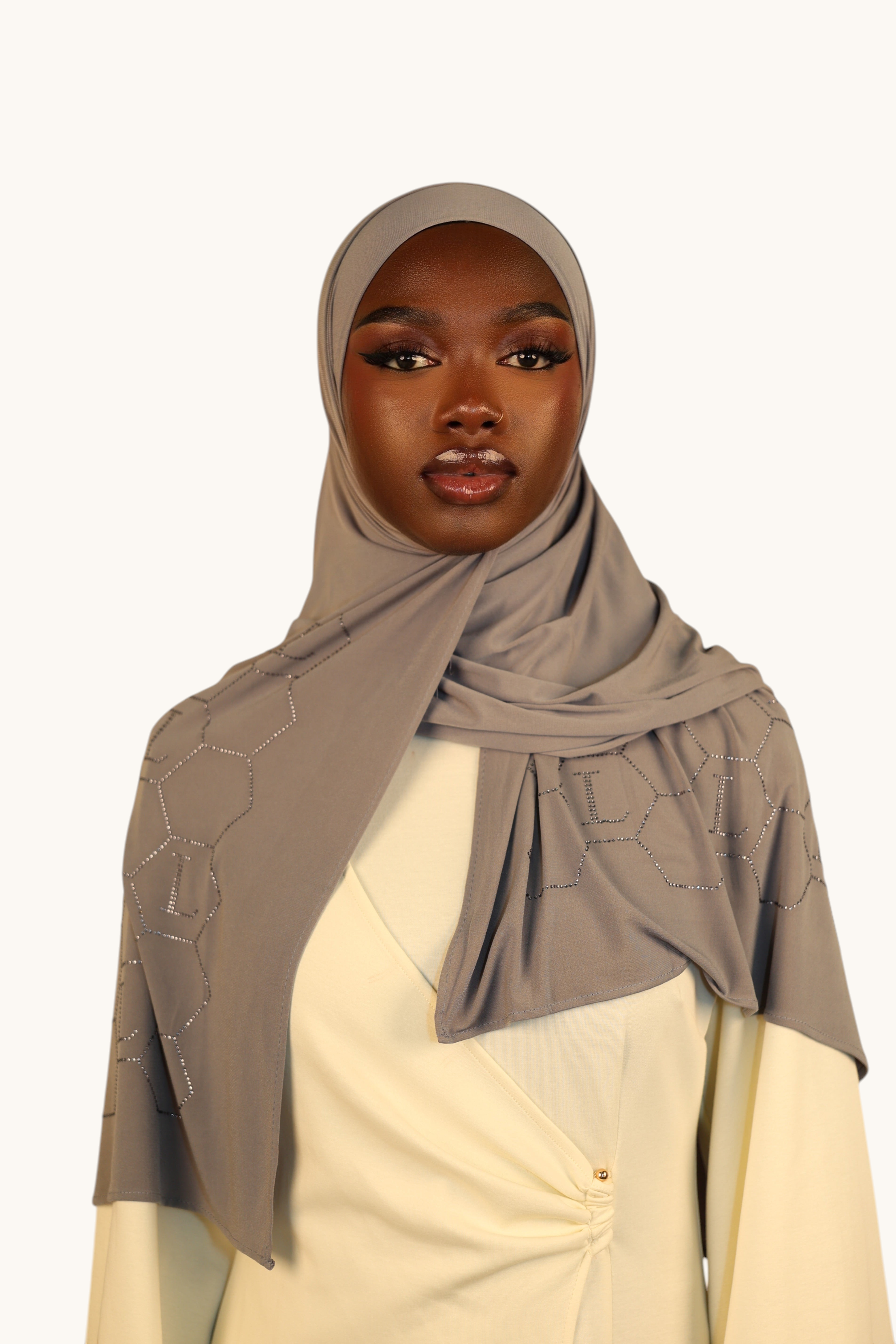 Model wearing a LOSYANA nude grey premium jersey hijab with sparkling rhinestone L-pattern details
