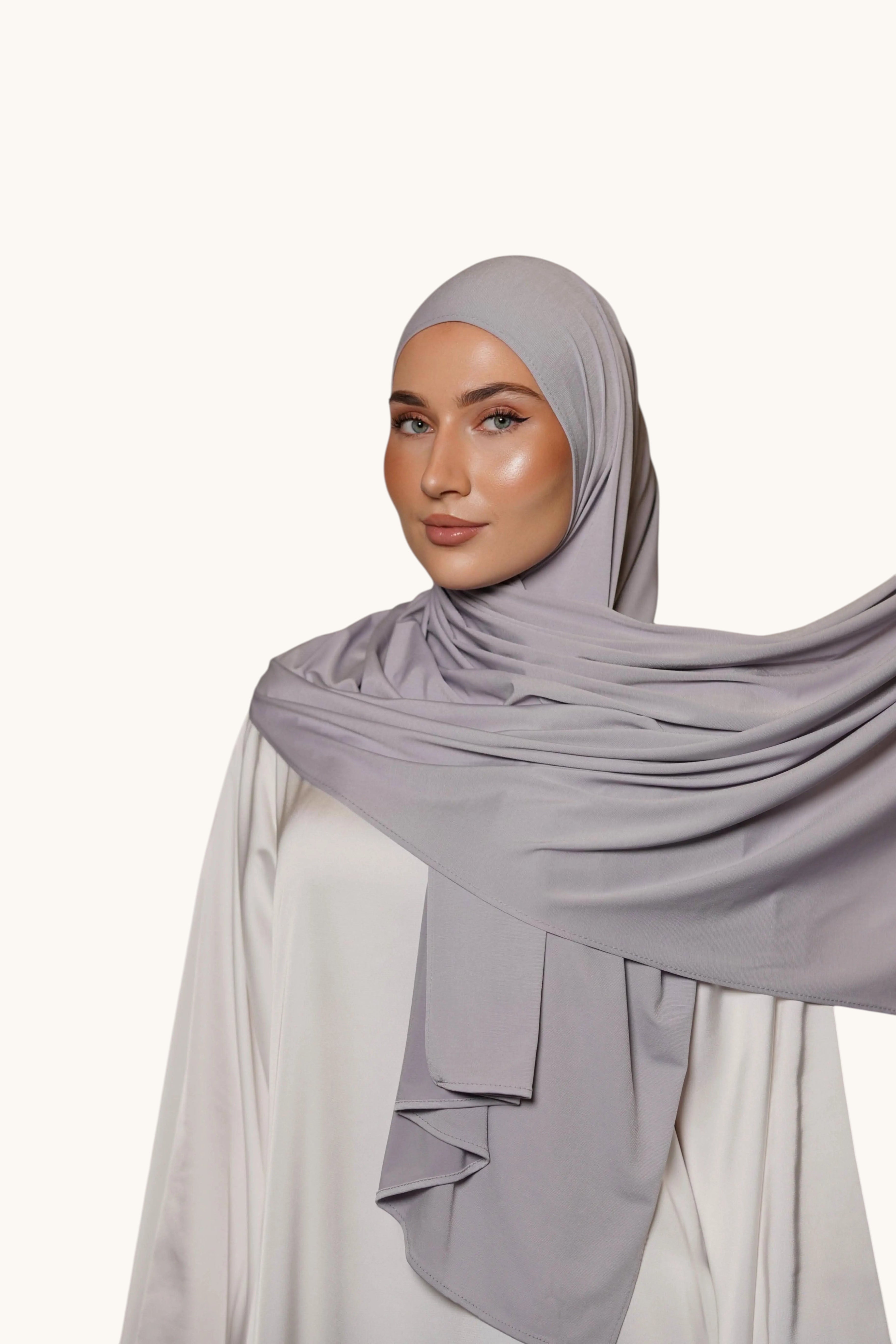 Model wearing a LOSYANA platinum grey premium jersey hijab, featuring a soft, opaque, and non-slip fabric drape.