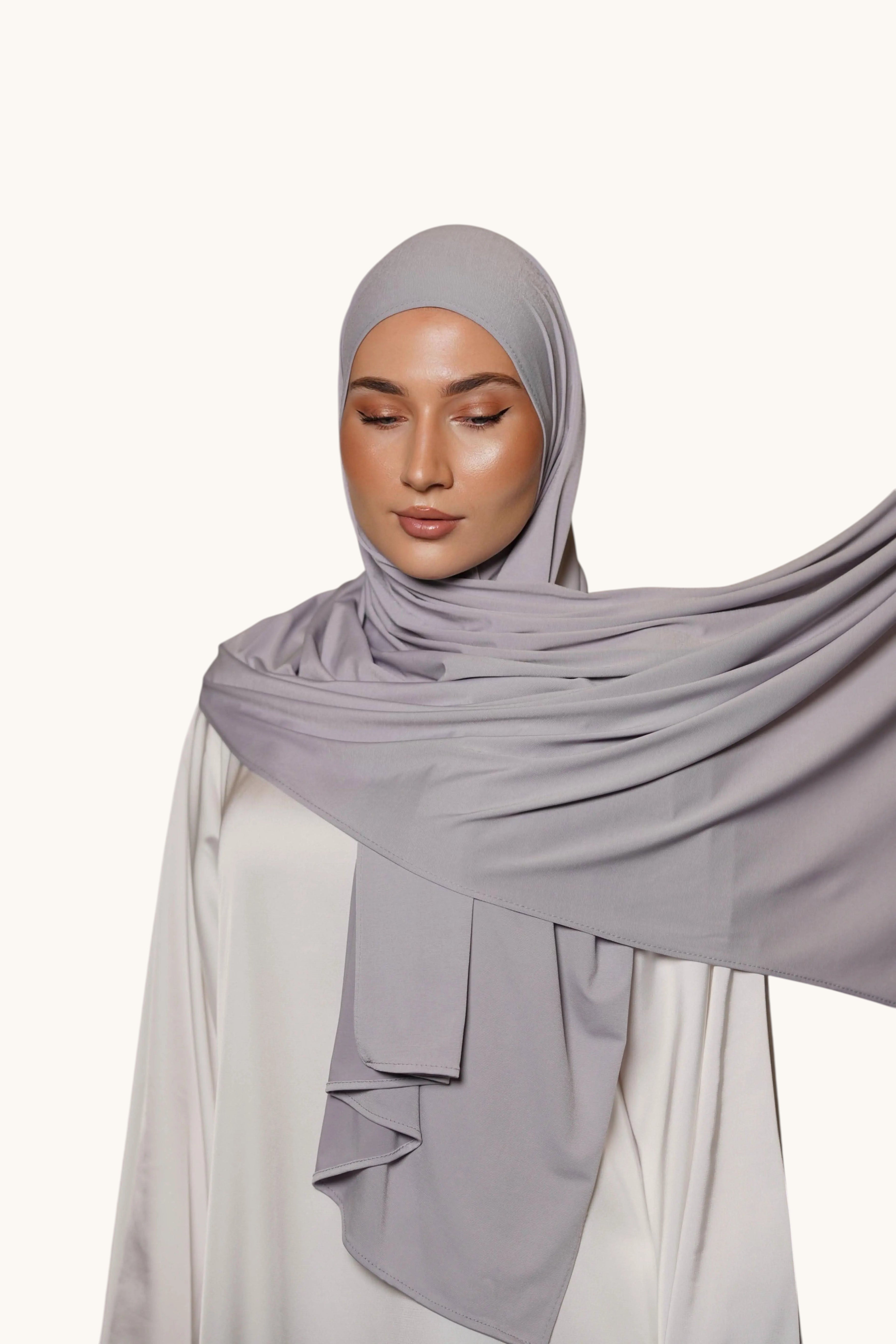 Model wearing a LOSYANA premium platinum grey jersey hijab, featuring a soft, non-slip, and opaque fabric drape.