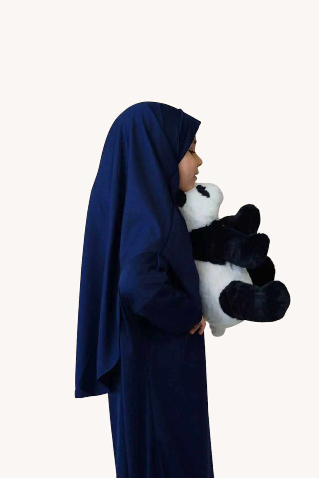 Young girl wearing a royal blue LOSYANA jersey prayer dress while holding a plush panda toy