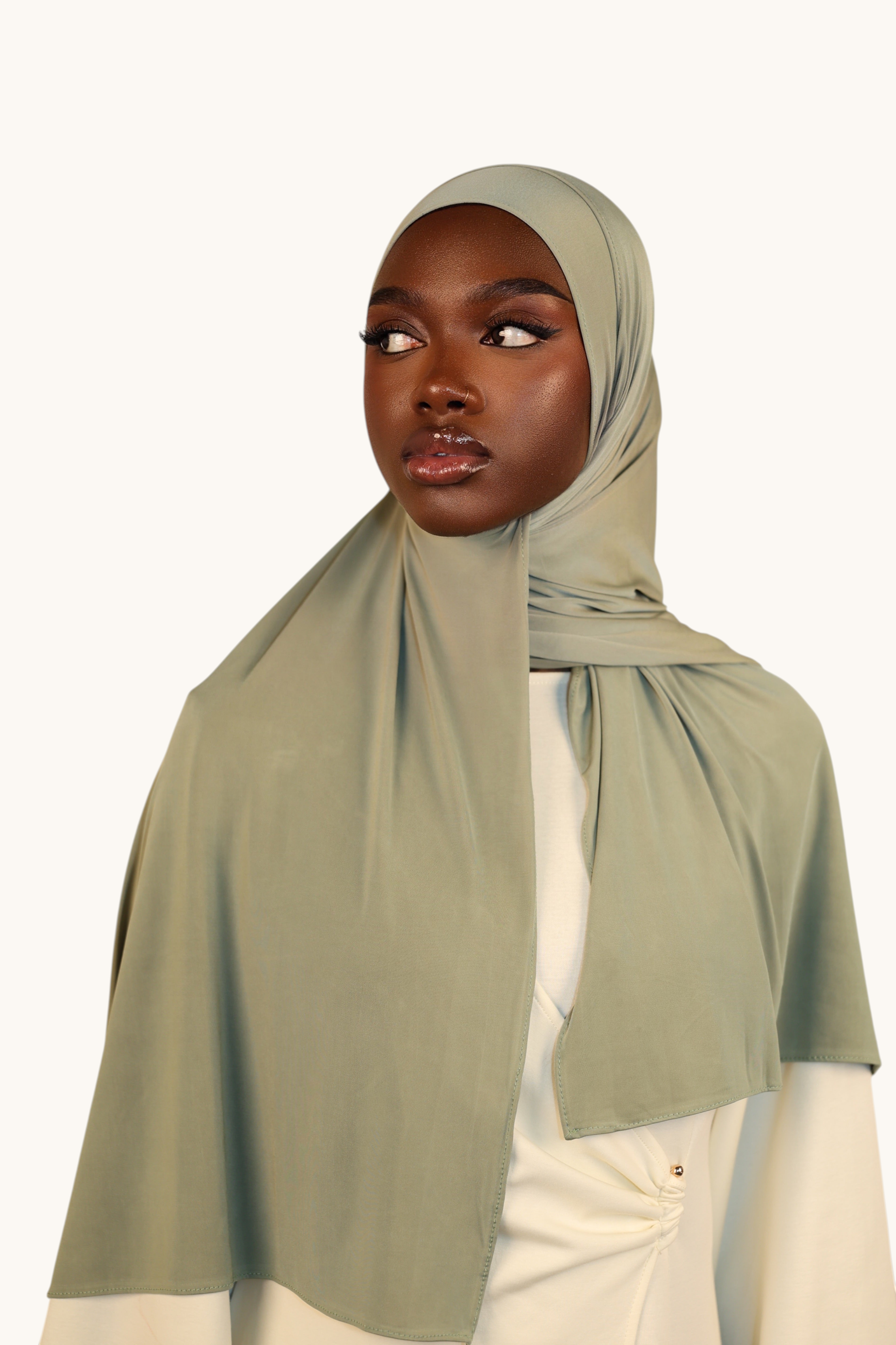 LOSYANA sage green liquid jersey hijab worn by a model, featuring a lightweight, elegant, and breathable fabric.