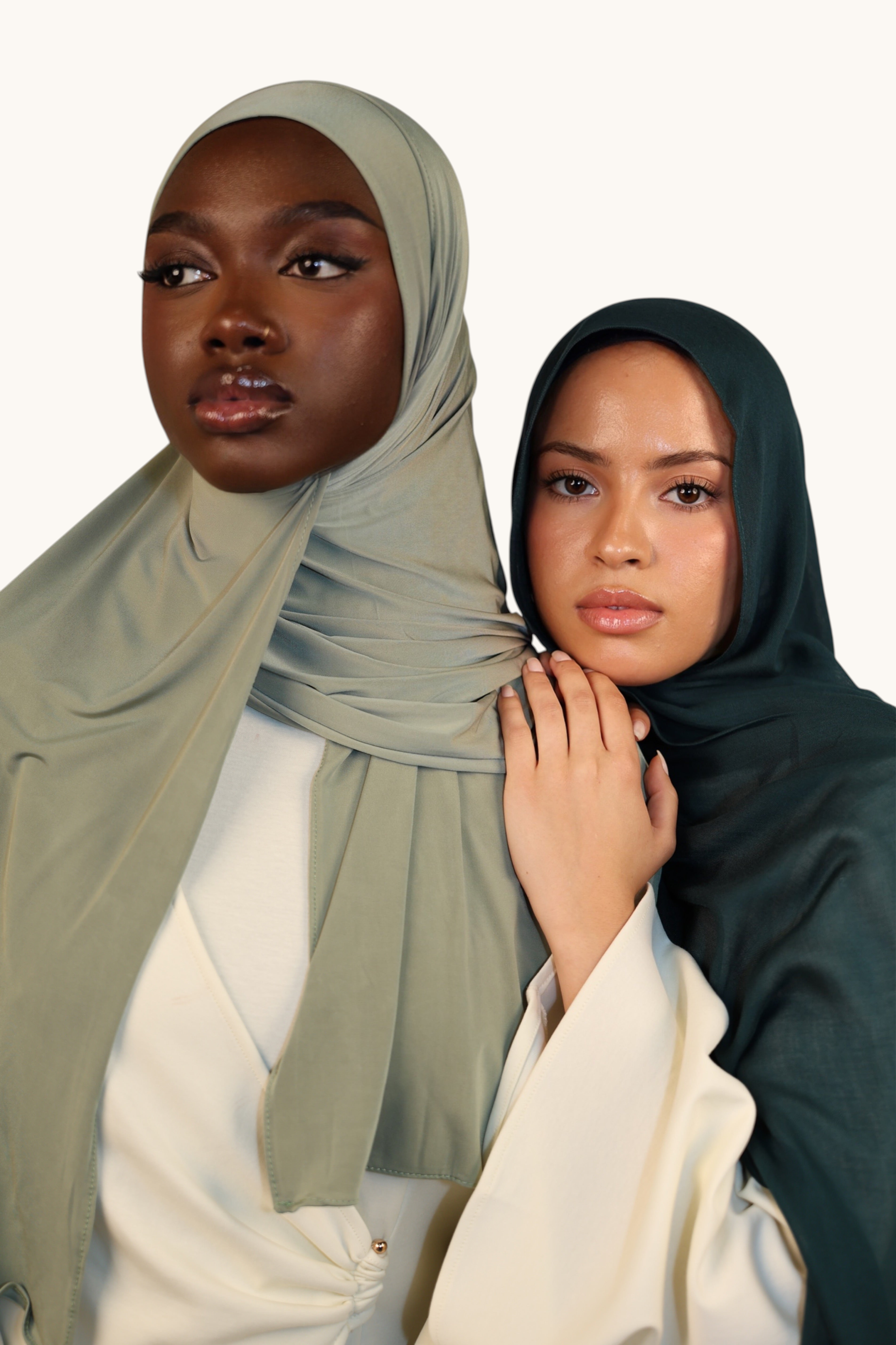LOSYANA Liquid Jersey hijab in sage green worn by a model next to another woman wearing a dark green headscarf