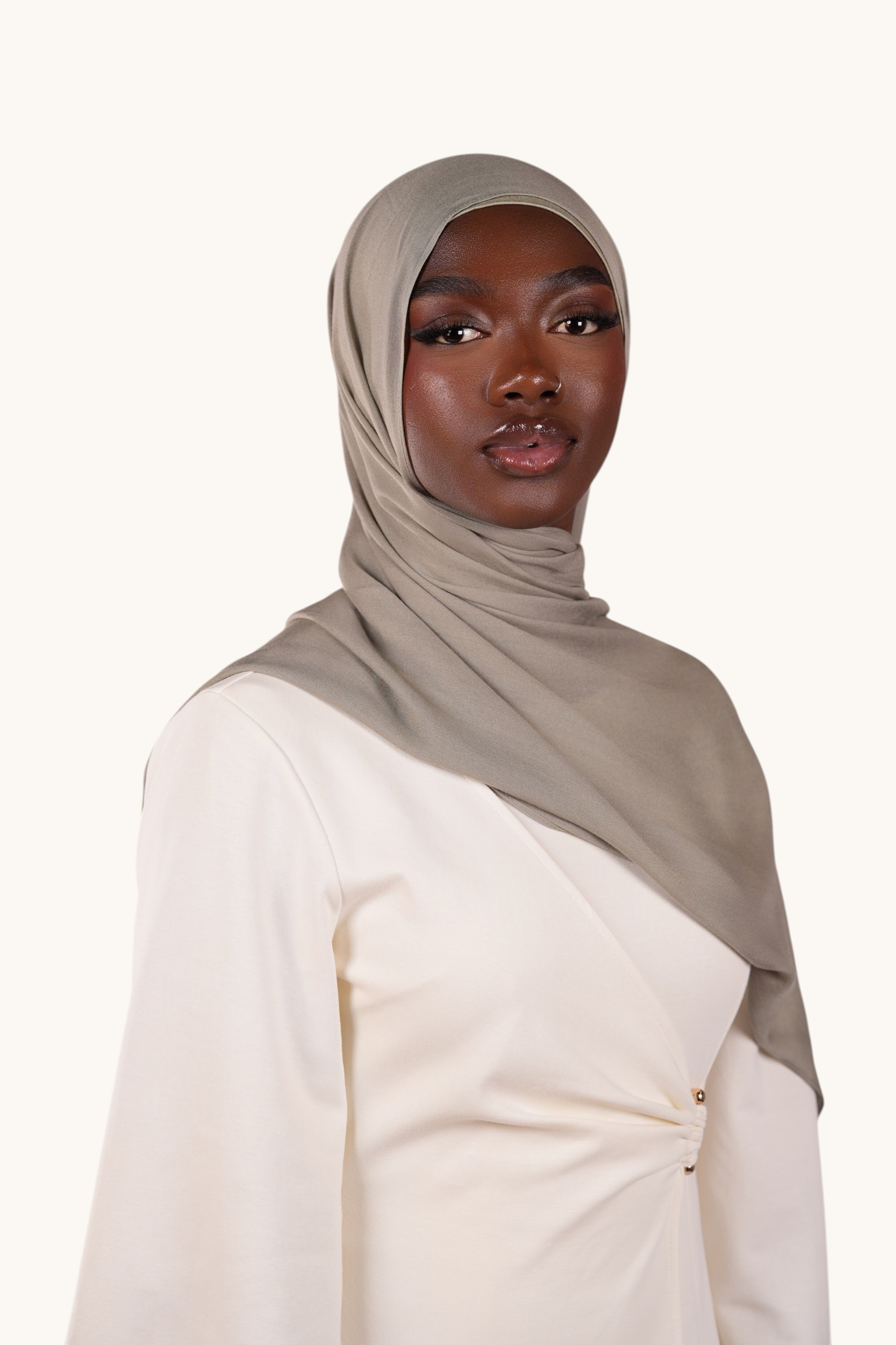 LOSYANA lightweight sage green modal hijab worn by a model, featuring a soft, elegant, and slightly sheer fabric.