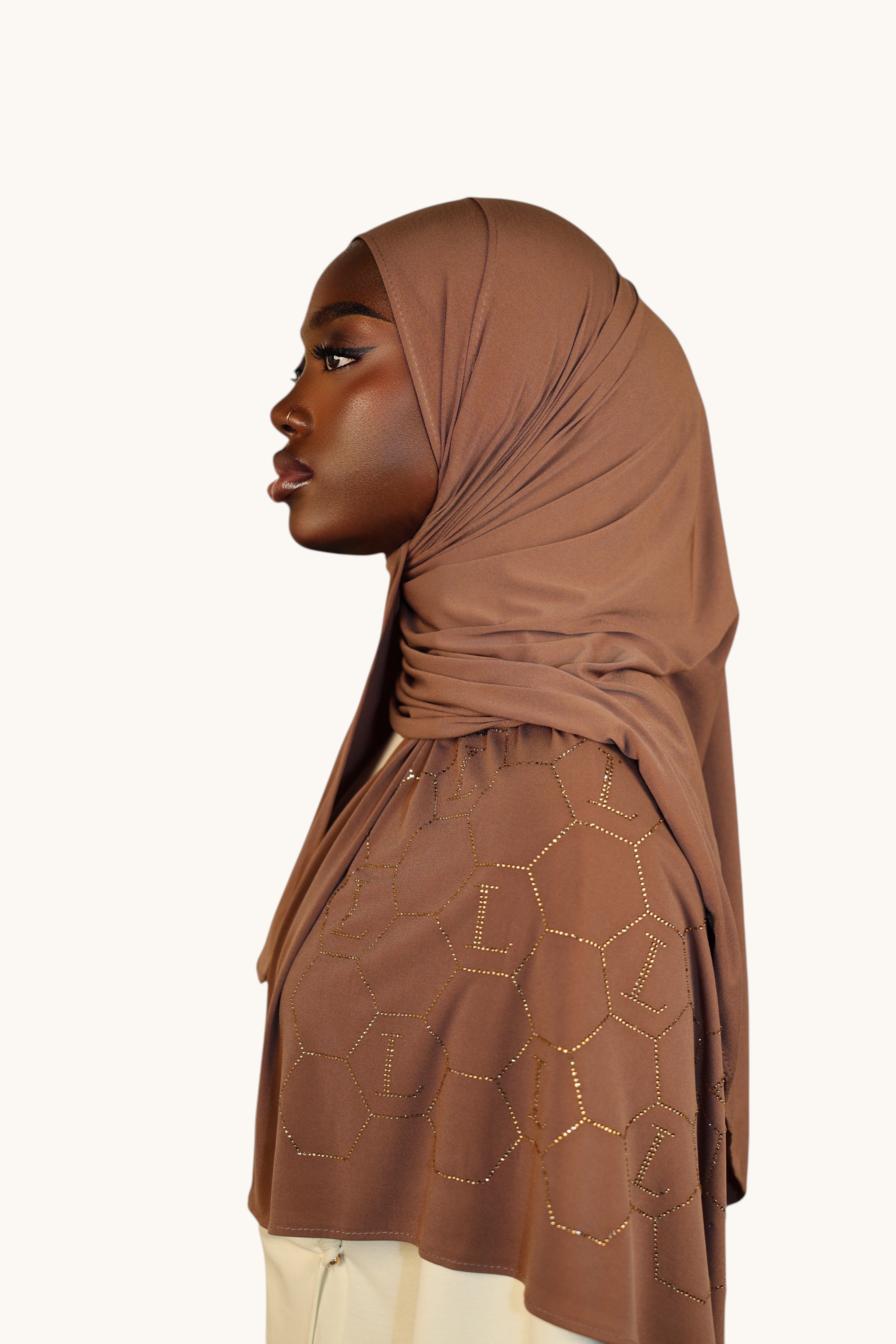 LOSYANA sahara premium jersey hijab with sparkling rhinestone L-pattern detail worn by a model in profile view