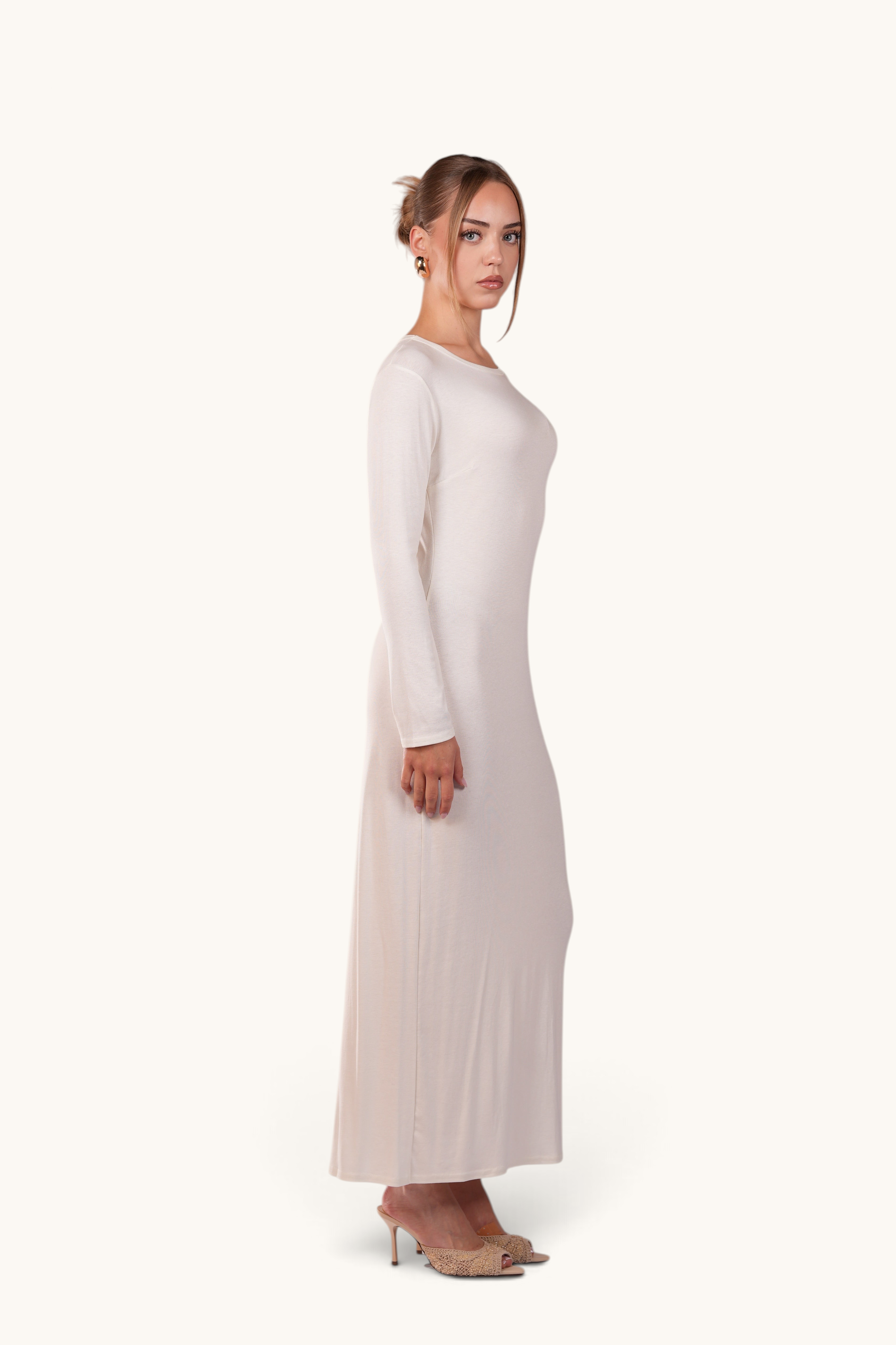 LOSYANA Sierra white long-sleeve maxi slip dress worn by a model, ideal as a base layer for summer outfits.
