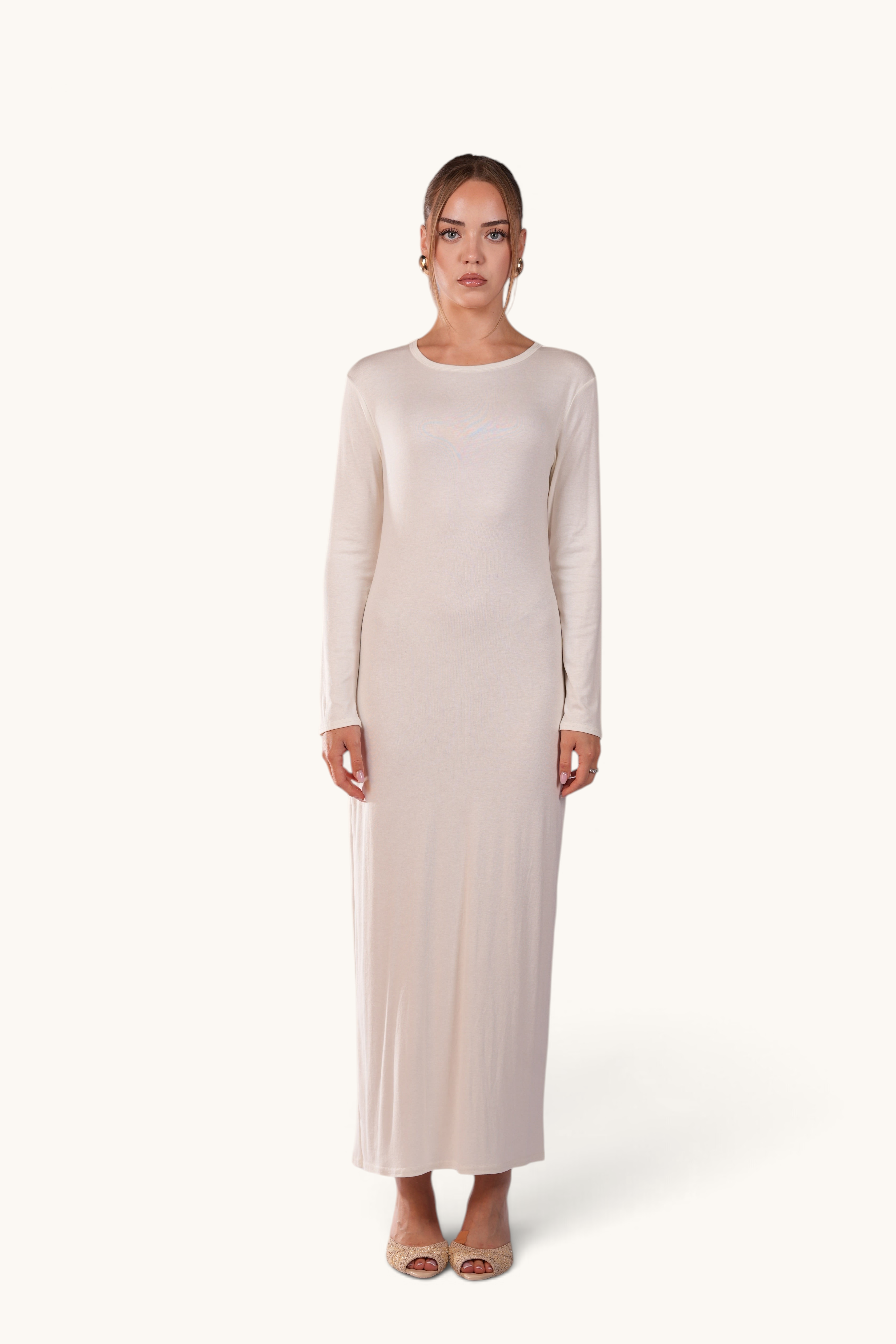 Model wearing a LOSYANA Sierra white long-sleeve maxi slip dress, perfect for layering under sheer summer outfits.