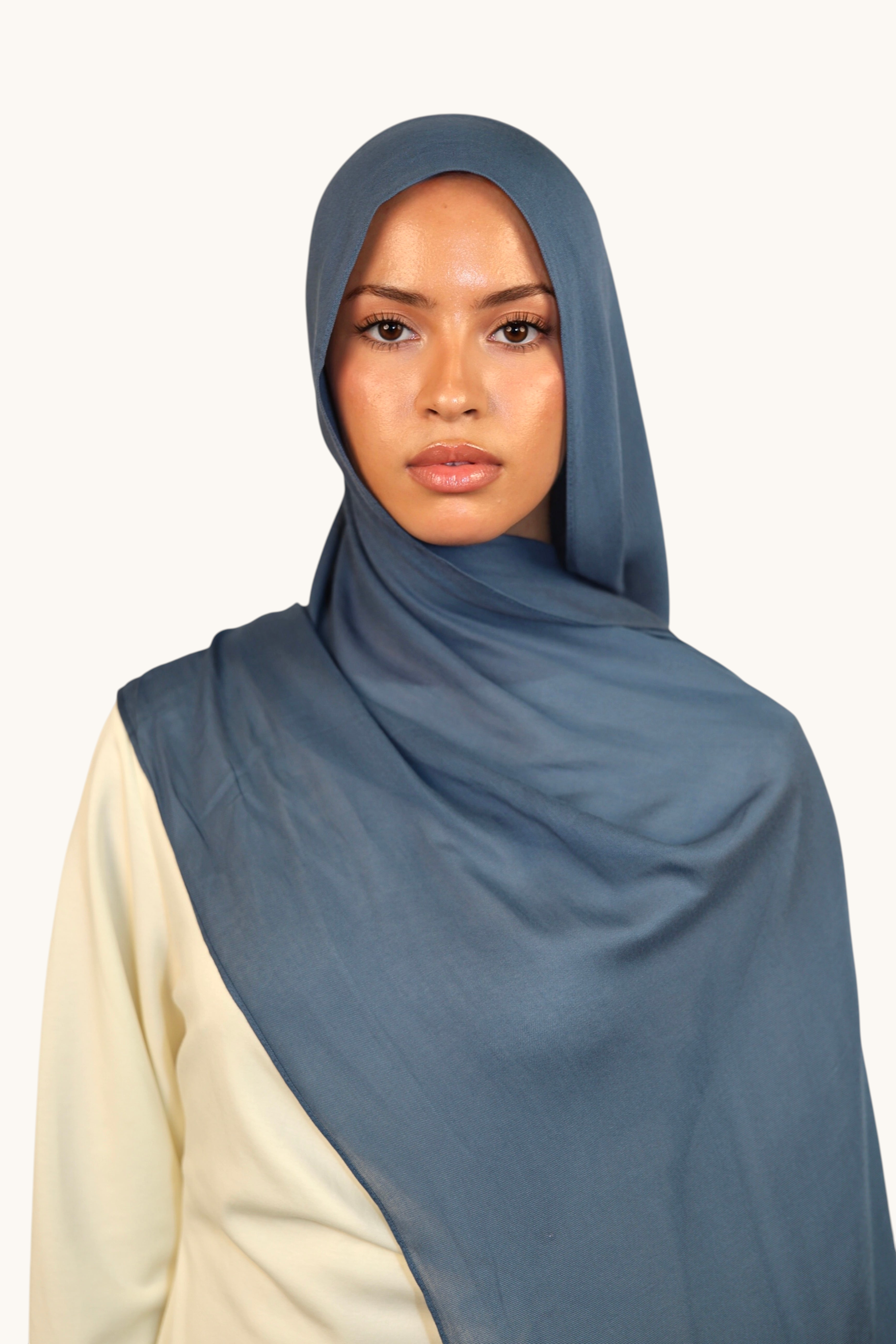 Model wearing a LOSYANA slate blue lightweight modal hijab with a soft, elegant drape against a white background.