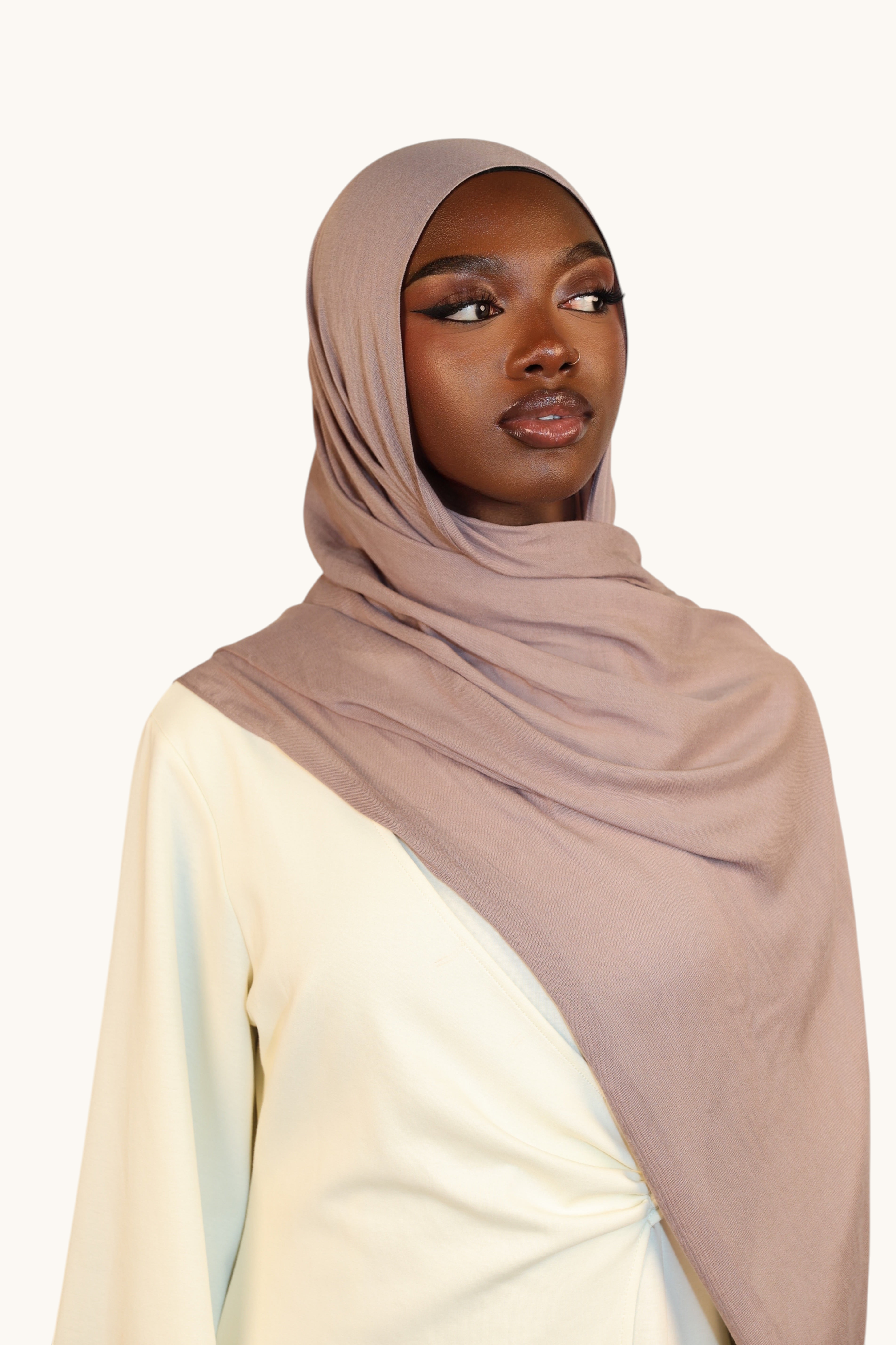 Model wearing a LOSYANA taupe gray lightweight modal hijab with a soft, elegant drape and matching undercap