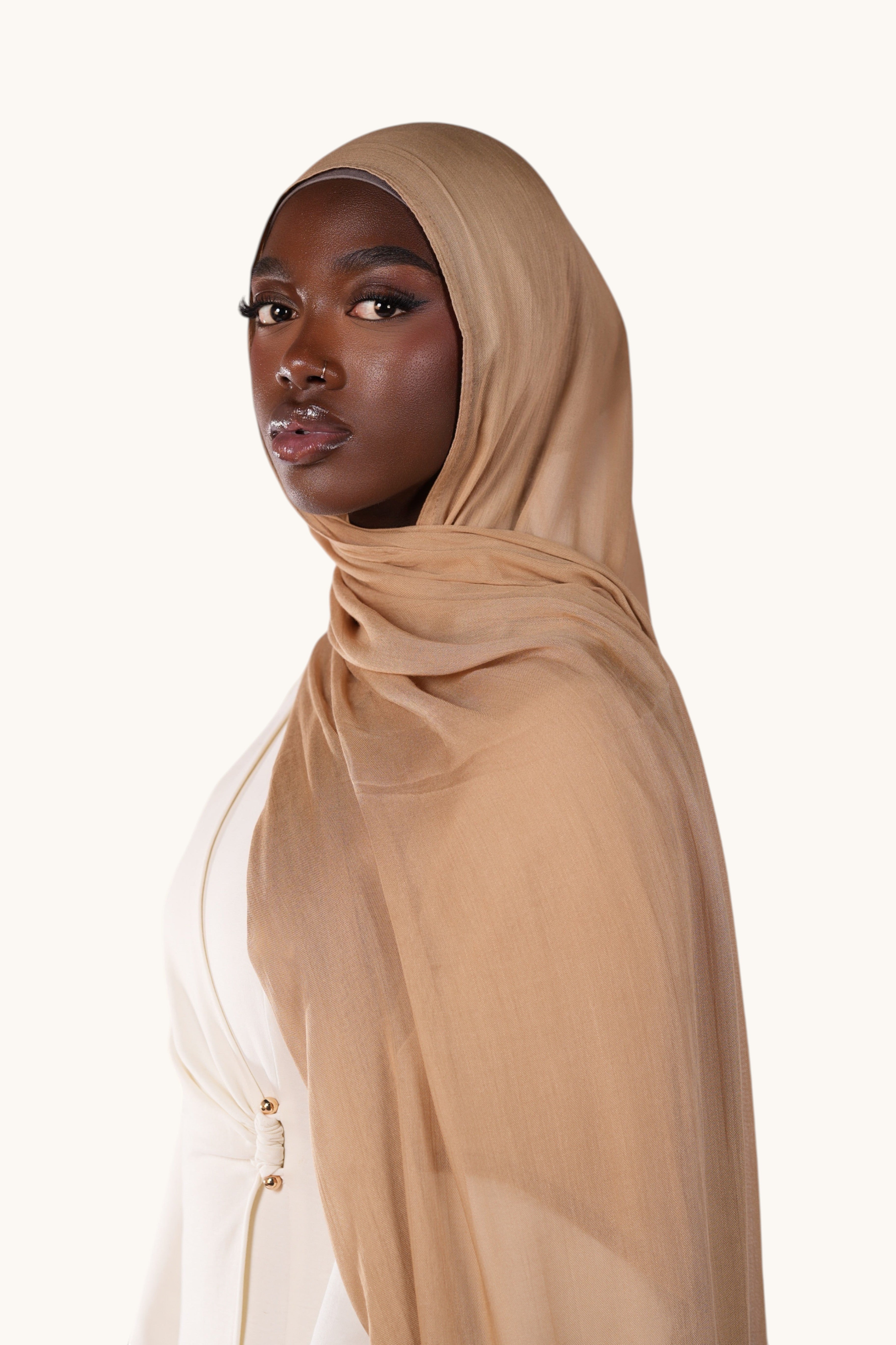 LOSYANA lightweight terracotta modal hijab worn by a model, featuring a soft, flowing, and slightly sheer fabric.