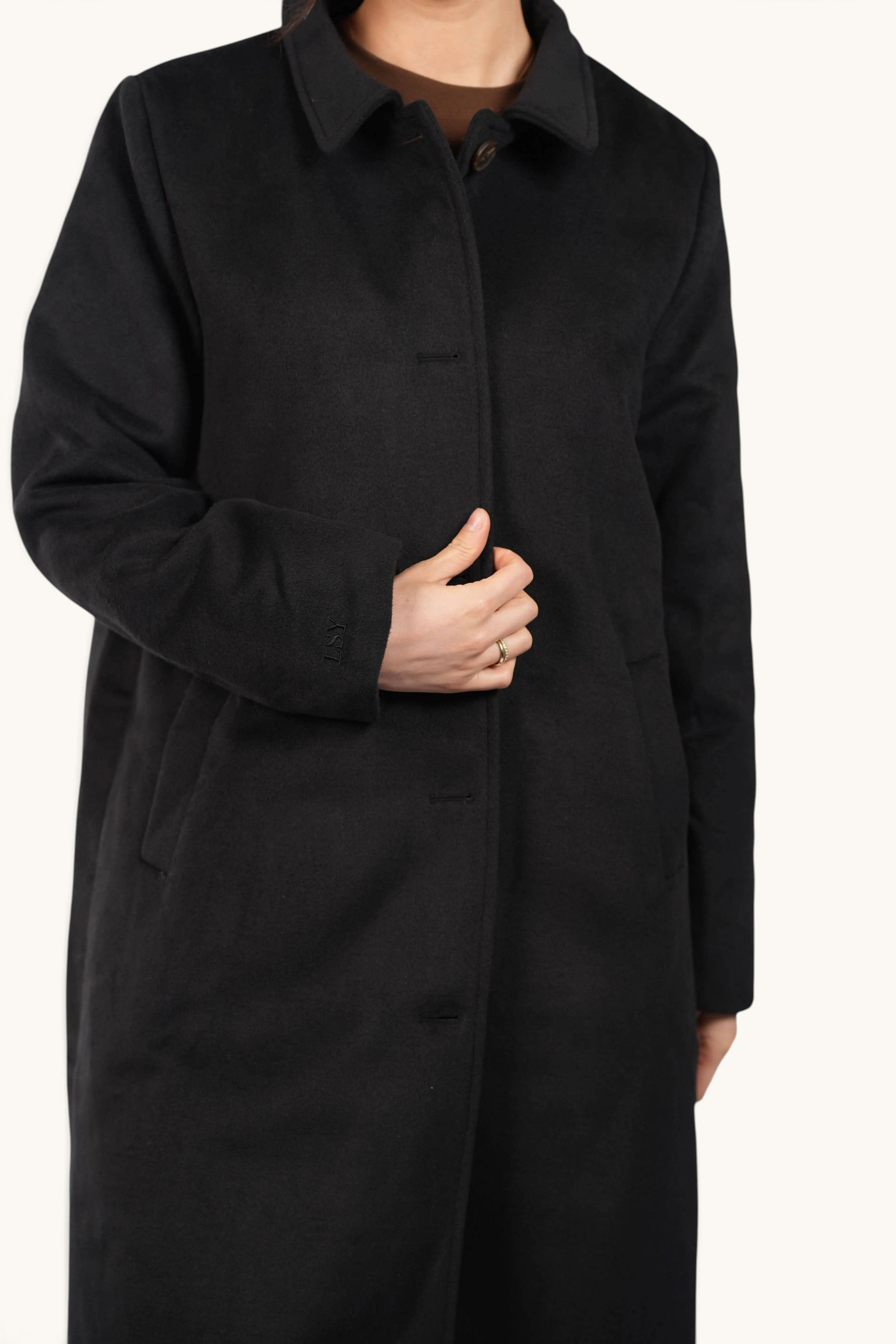 LOSYANA The Vienna Coat in black featuring a classic collar, button-up front, and subtle LSY embroidery on the cuff.