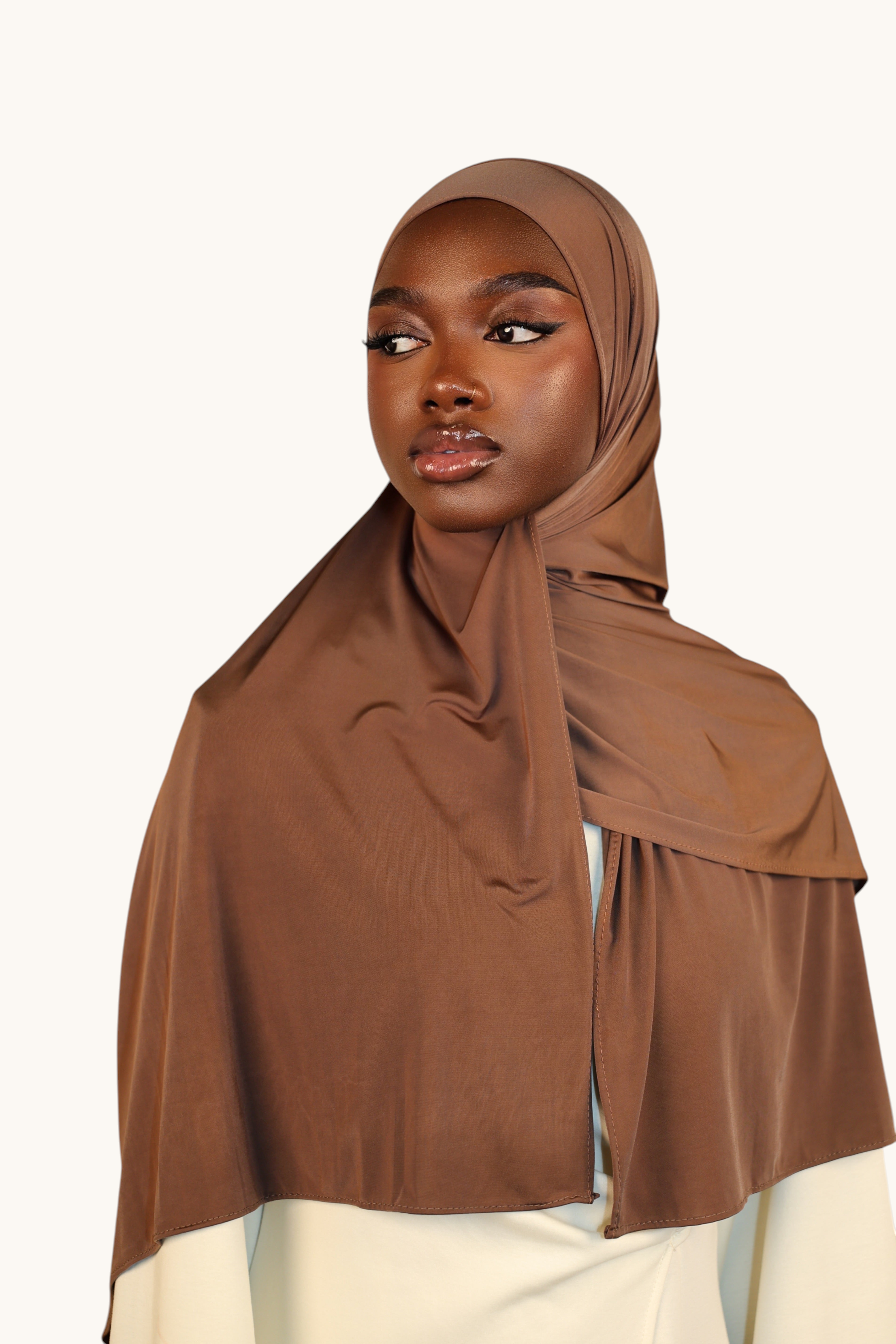 LOSYANA toffee brown liquid jersey hijab worn by a model, featuring a lightweight, elegant, and subtle sheen fabric.